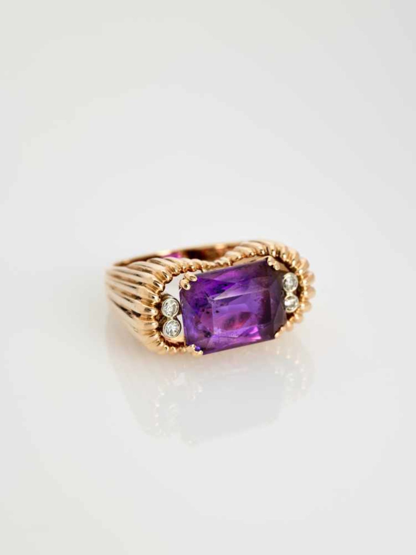 A DEEP PURPLE AMETHYST AND DIAMOND 14 CARAT PINK GOLD RINGAustriaAttributed to Erwin Paltscho, after