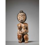 A WOOD MATERNITY FIGURE, GABON, PUNU PEOPLEPainted wood, kaolinGabon, Punu people20th centuryThe