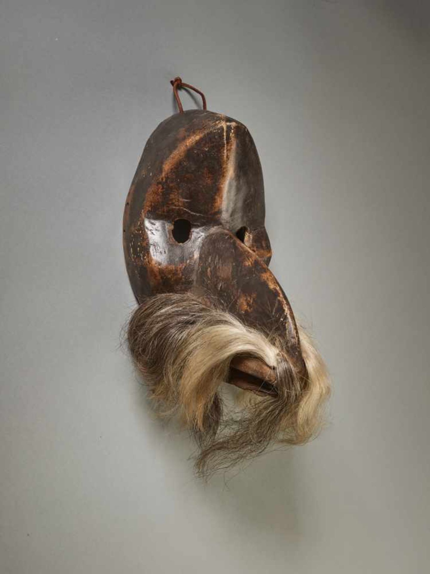 A GÄGON BIRD MASK, CÔTE D’IVOIRE / LIBERIA, DAN PEOPLEWood with painted metal, black ape hair,