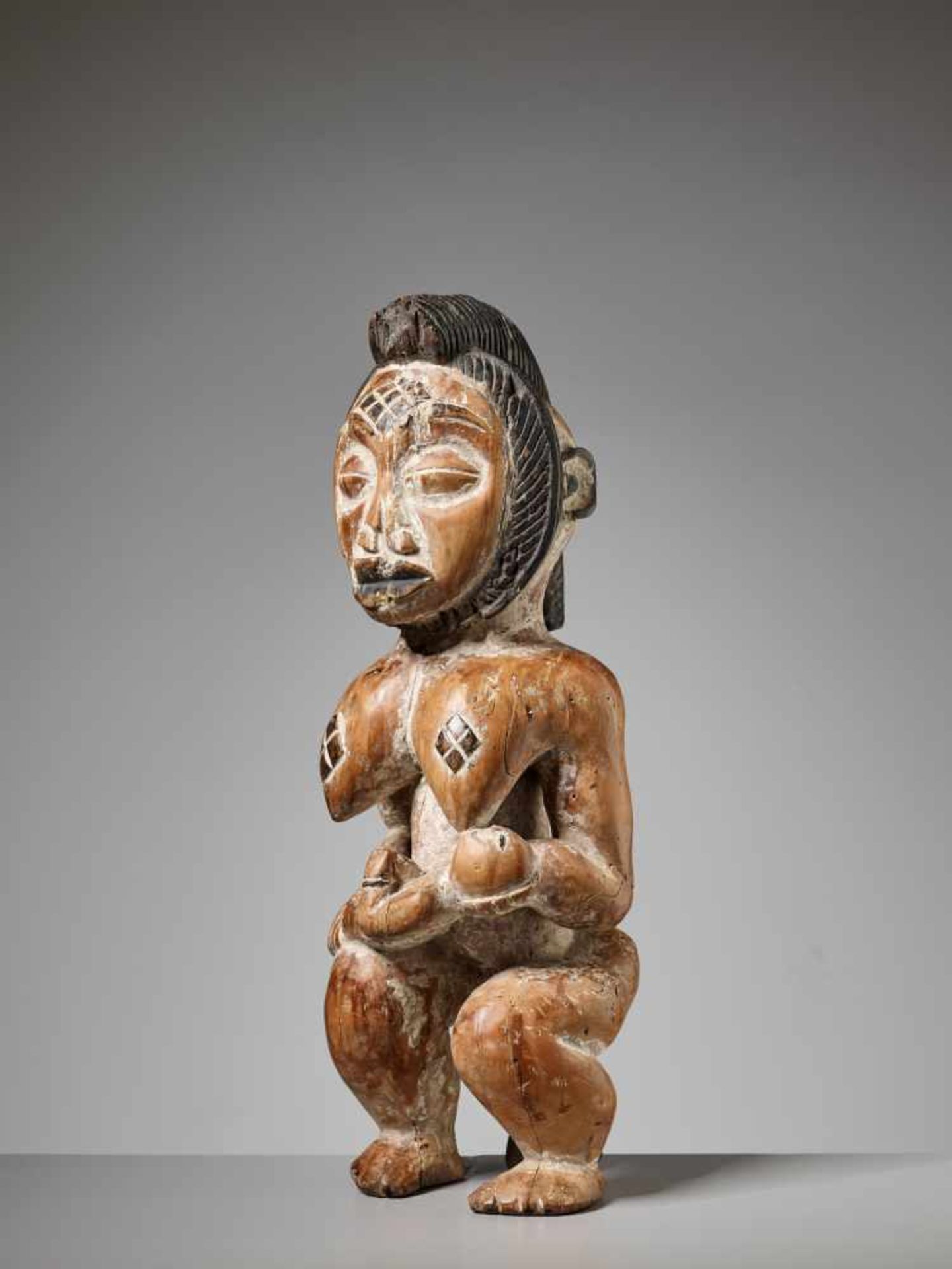 A WOOD MATERNITY FIGURE, GABON, PUNU PEOPLEPainted wood, kaolinGabon, Punu people20th centuryThe - Image 2 of 6