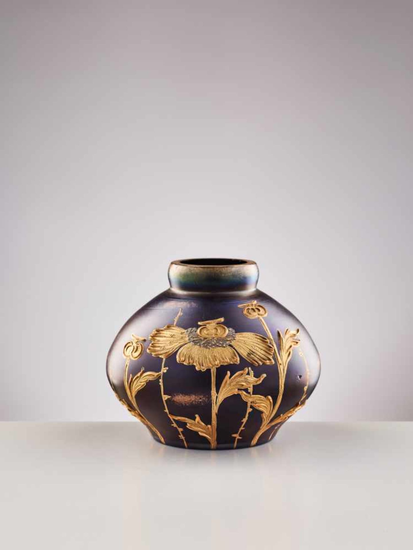 A SMALL JUGENDSTIL GLASS VASE WITH HAND-PAINTED GILT DECORATIONSTransparent violet, slightly