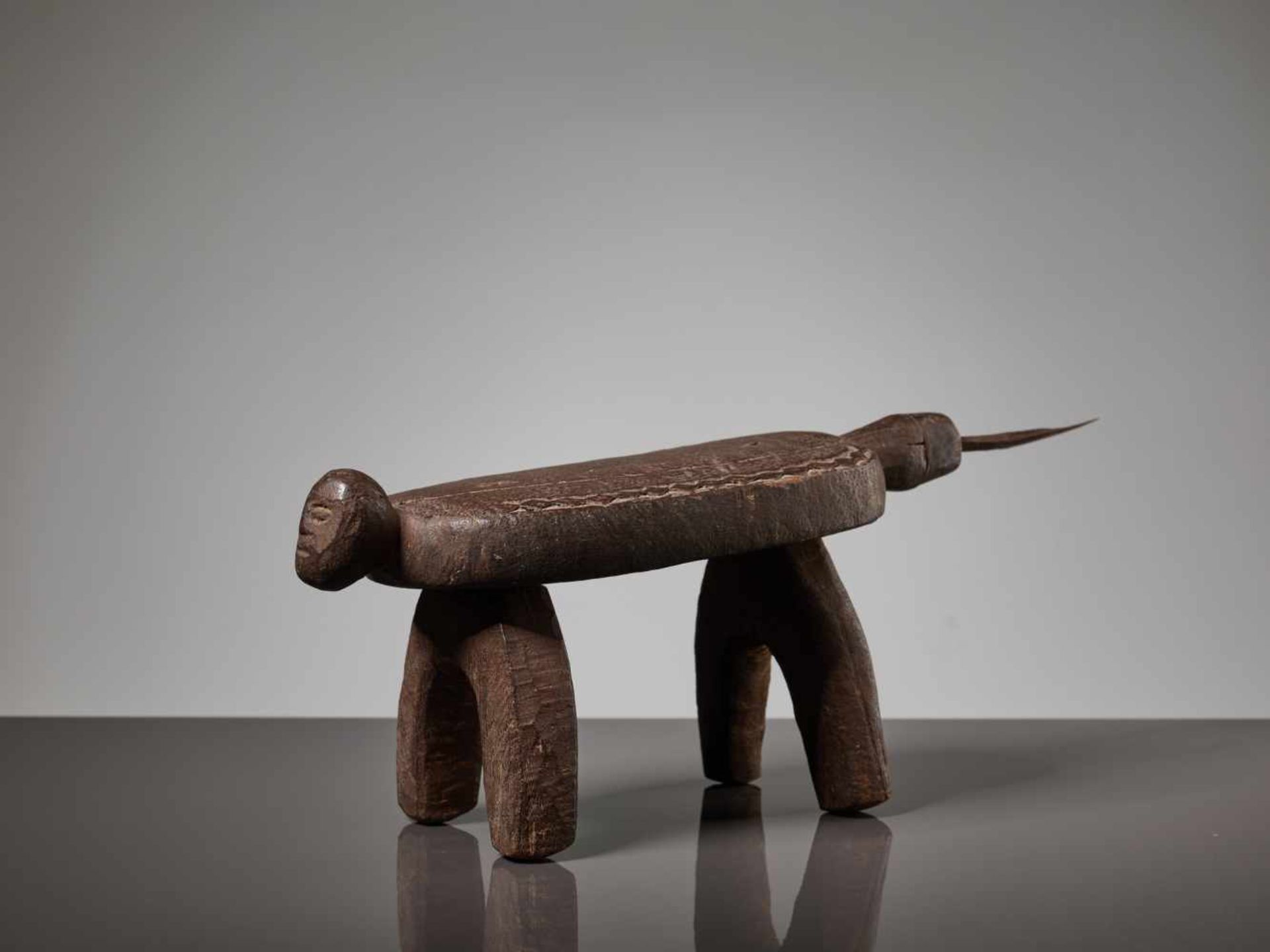 A WOODEN STOOL WITH A HUMAN FACE, BURKINA FASO, LOBI PEOPLEBrown painted wood, iron bladeBurkina - Image 4 of 8