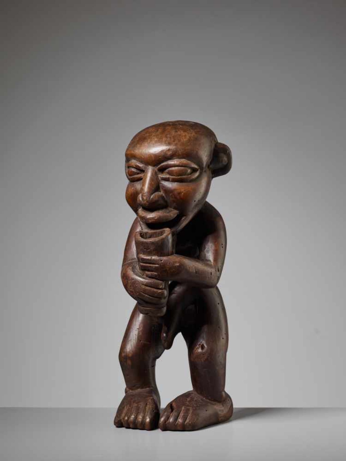 A WOOD STATUE OF A MEDICINE MAN, NIGERIA, YORUBA PEOPLEWood, animal horn pendantNigeria, Yoruba