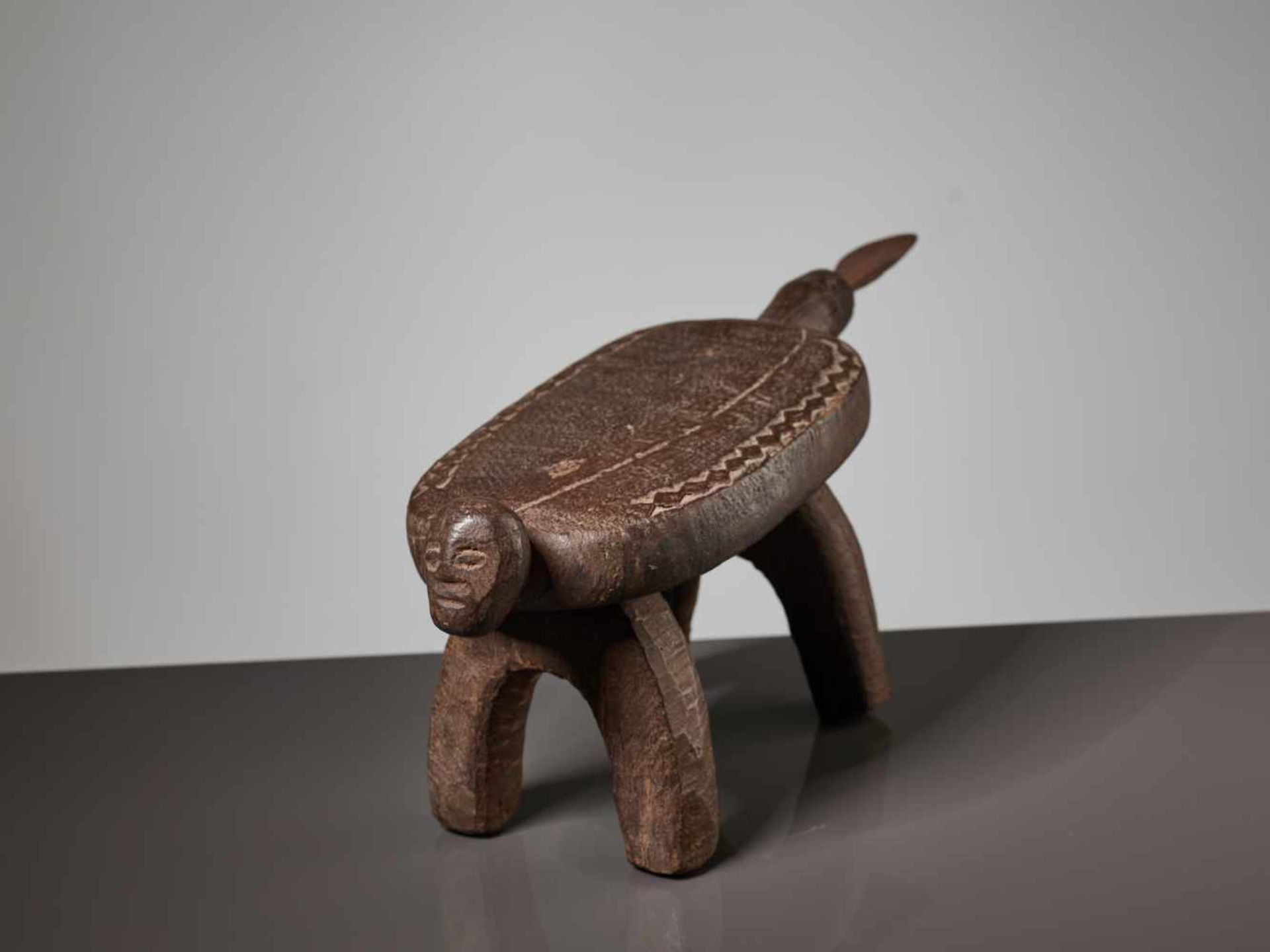 A WOODEN STOOL WITH A HUMAN FACE, BURKINA FASO, LOBI PEOPLEBrown painted wood, iron bladeBurkina - Image 6 of 8