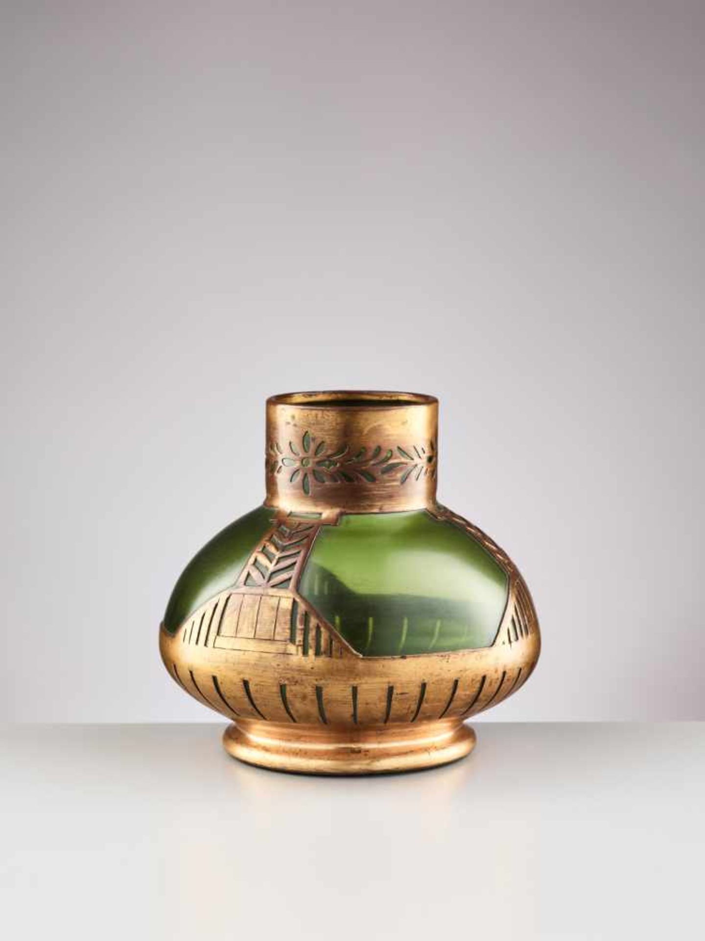 A SMALL JUGENDSTIL GLASS VASE WITH GOLD PATINATED COPPER RELIEFTransparent green, slightly