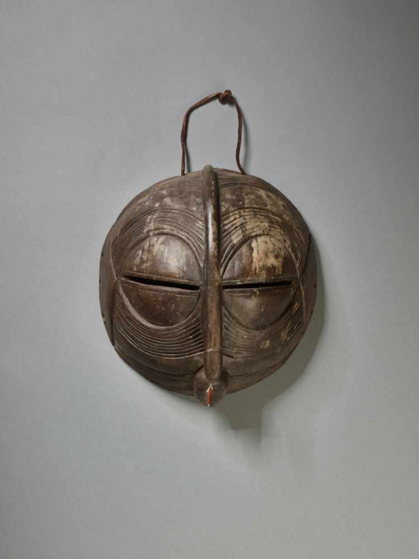 A ROUND KIFWEBE MASK, CONGO, LUBA PEOPLEWood with remnants of paint, leather stringDemocratic