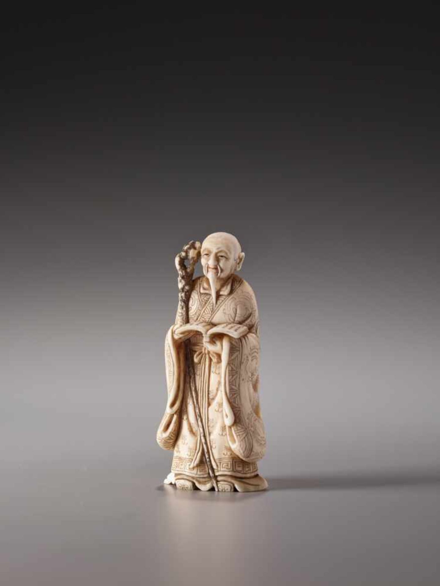 AN IVORY NETSUKE OF A TAOIST SAGE WITH A BOOK AND SAGEMONO BY MEIKEIIvory netsukeJapan, Kyoto20th - Image 2 of 9