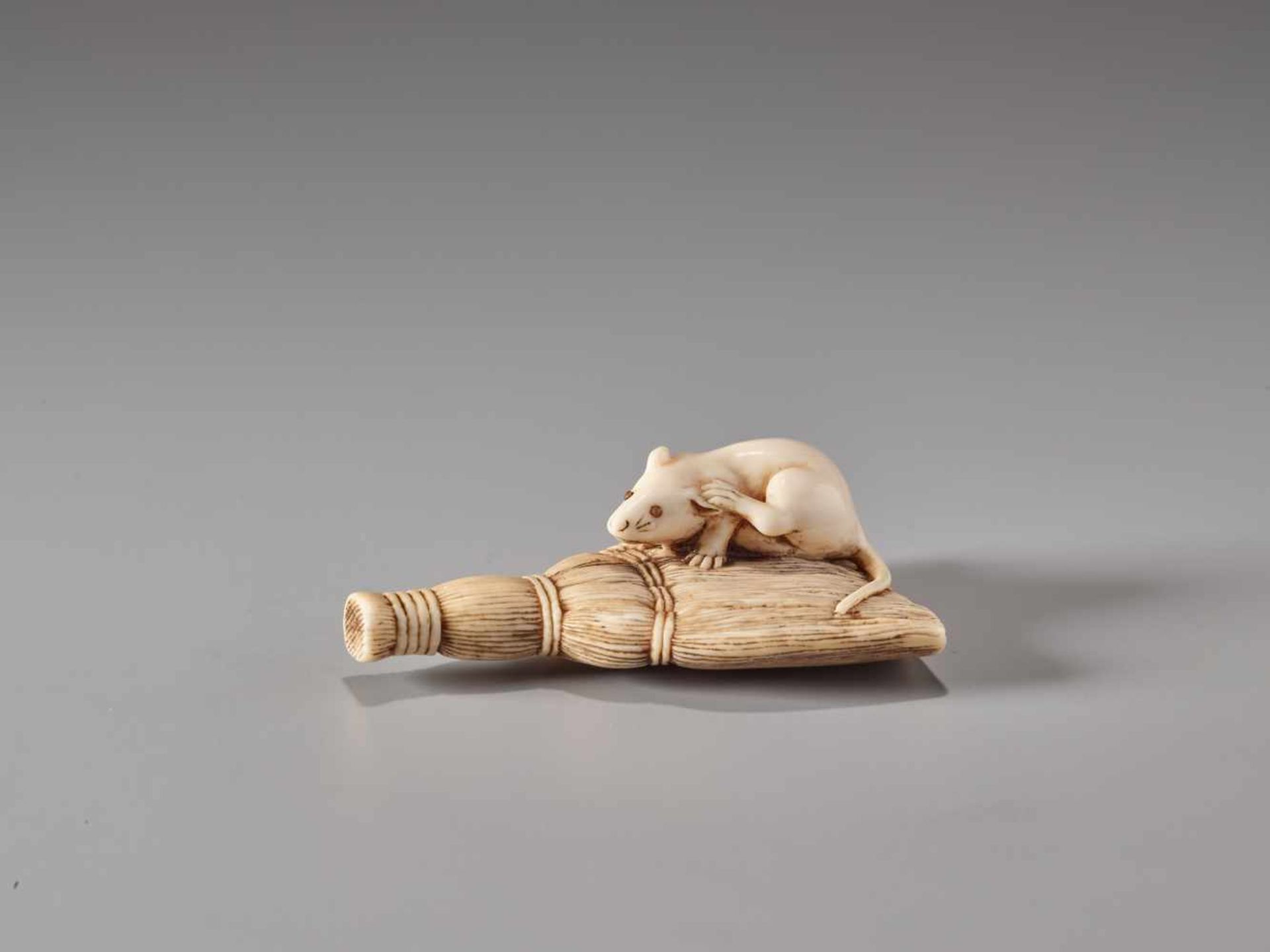 AN IVORY NETSUKE OF A RAT ON A BROOMIvory netsukeJapan19th century, Edo period (1615-1868)This - Image 2 of 4