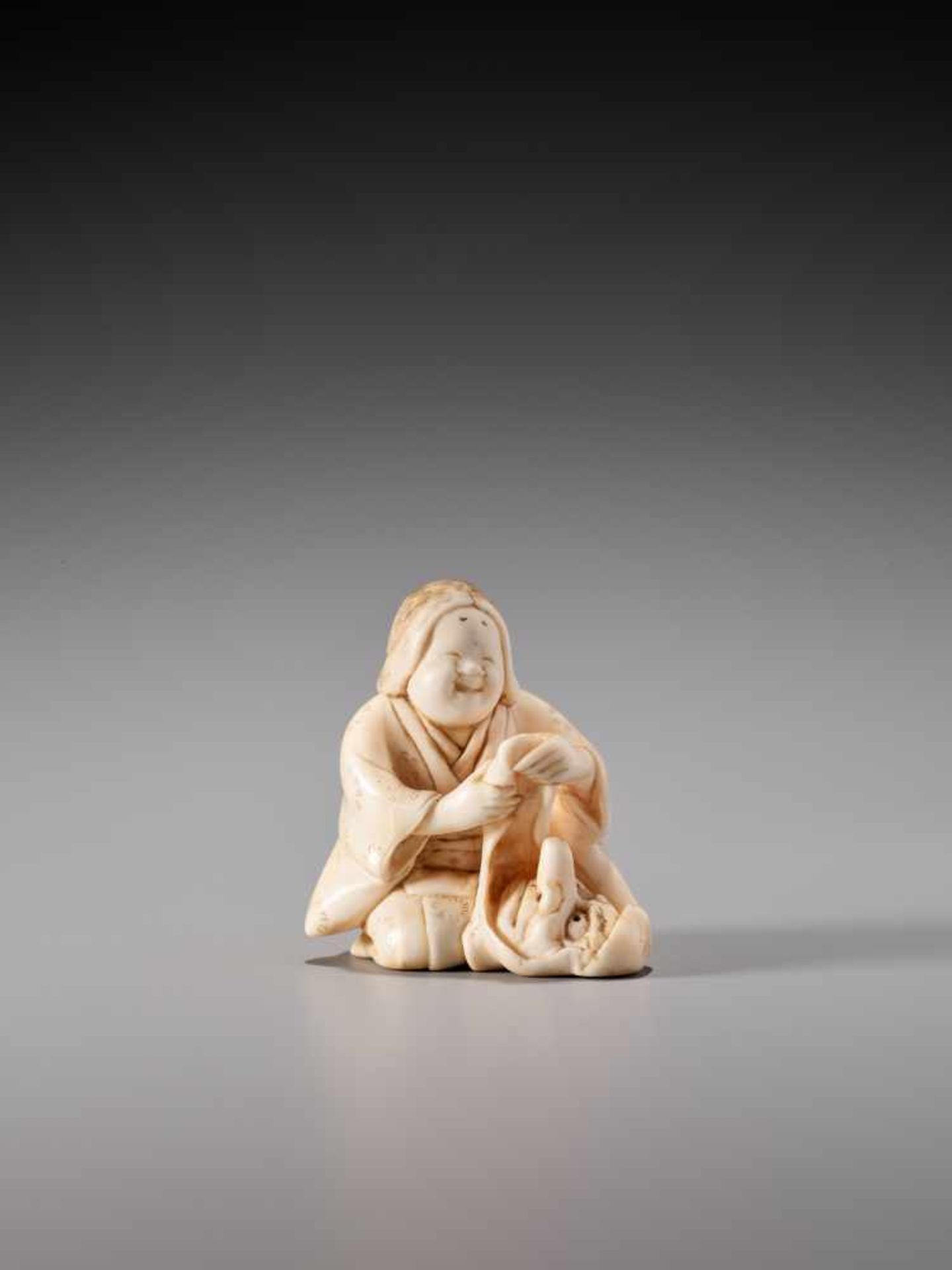 AN IVORY NETSUKE OF OKAME WITH TENGU MASK BY GYOKUZANIvory netsukeJapan, Tokyolate 19th century, - Image 2 of 8