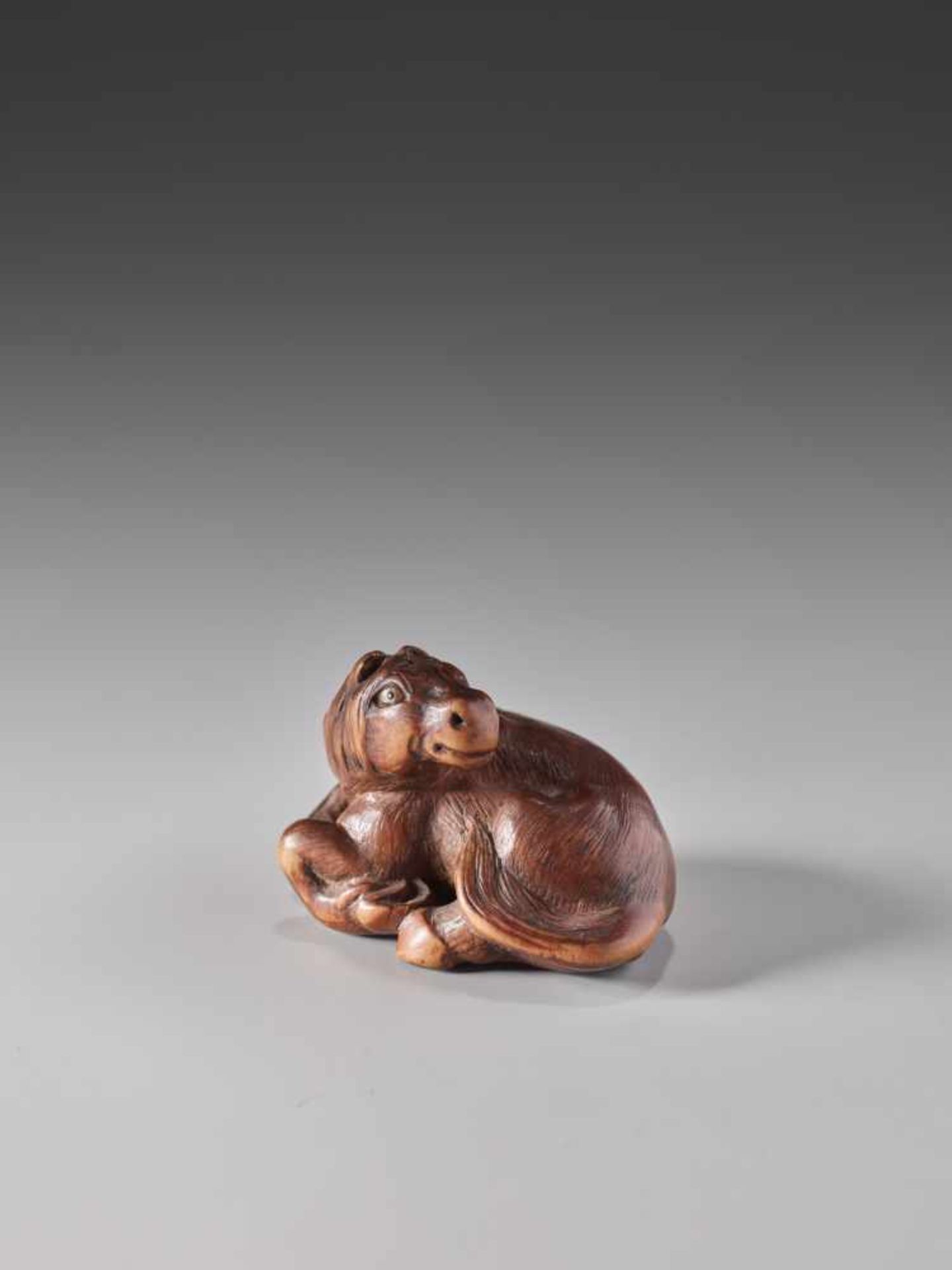 A RARE WOOD NETSUKE OF A RECUMBENT HORSE BY KOKEIWood netsukeJapan, Tsu, Kuwana, Ise Provincefirst