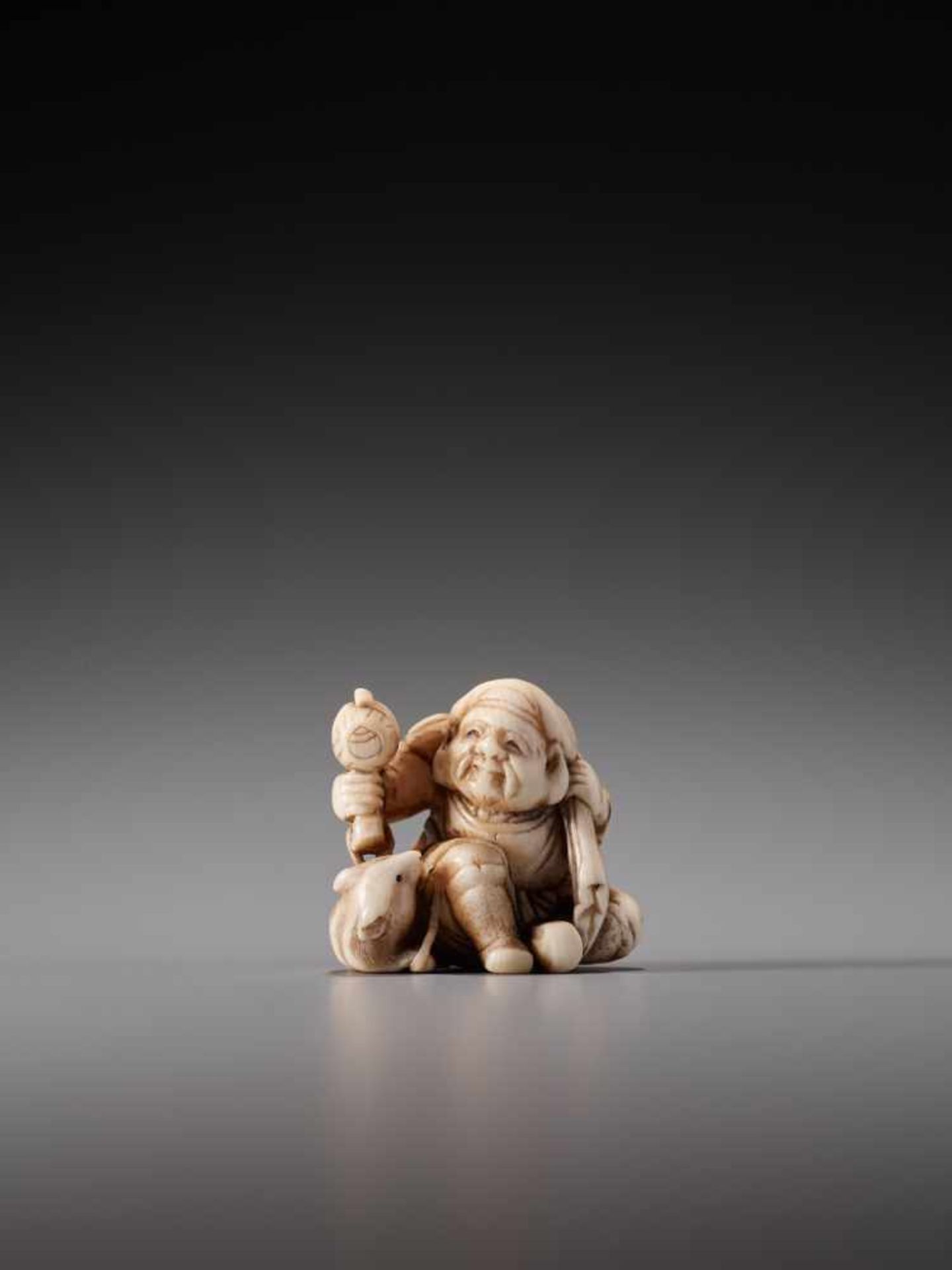 A CHARMING IVORY NETSUKE OF DAIKOKU WITH RATIvory netsukeJapan19th century, Edo period (1615-1868)