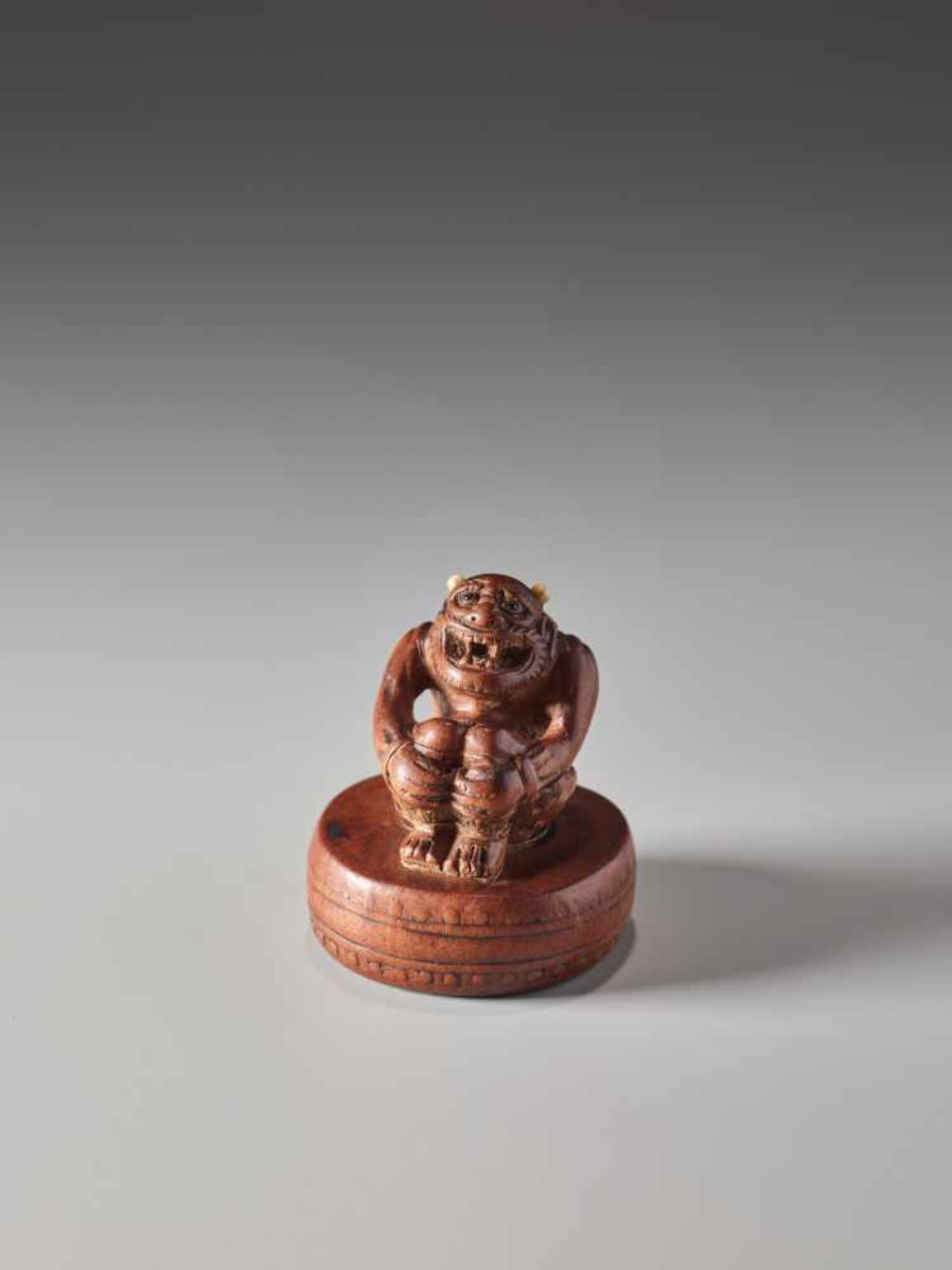 A WOOD NETSUKE OF THE GOD OF THUNDER RAIJINWood netsuke with small inlaysJapan19th century, Edo