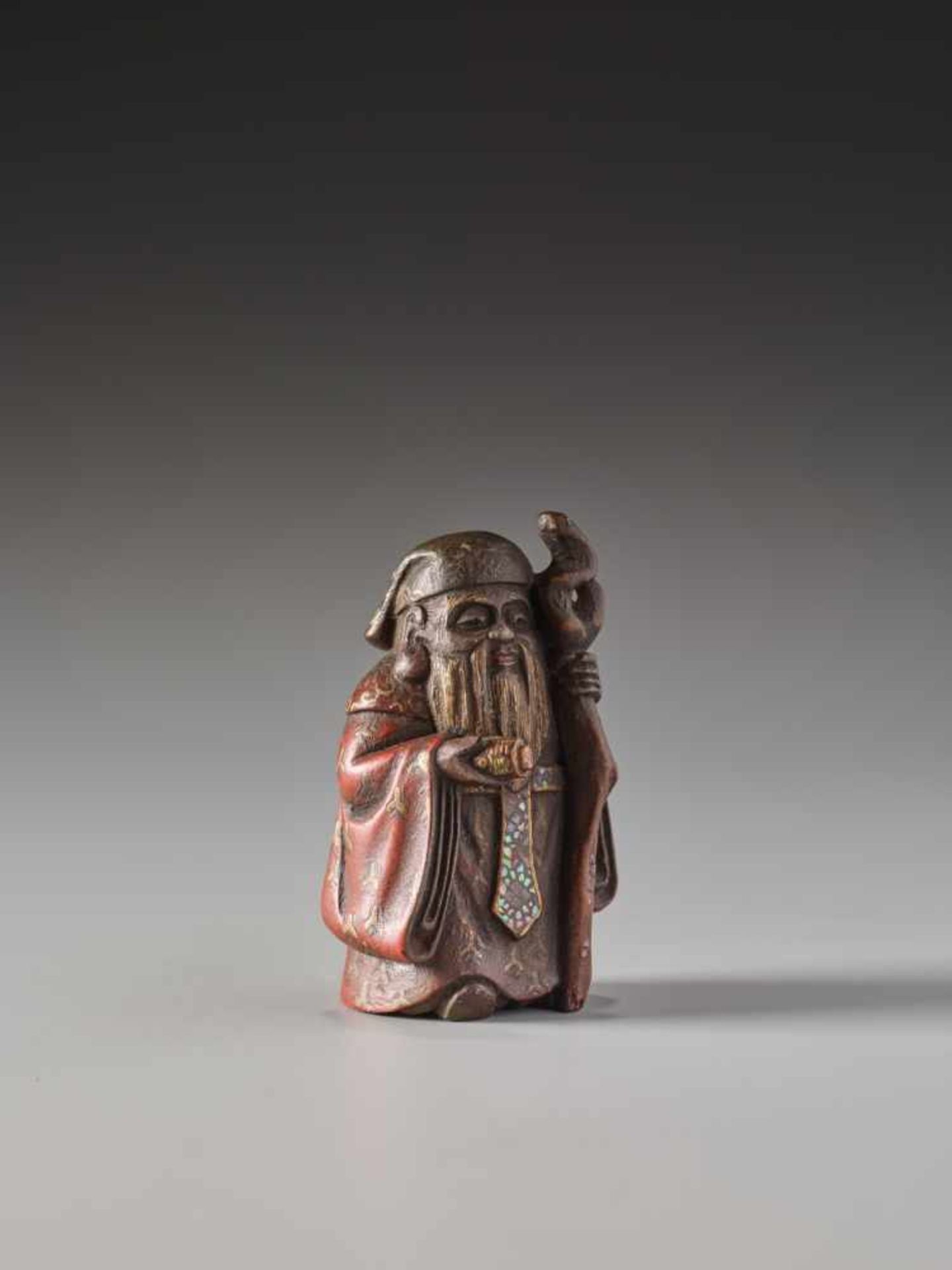 A SMALL LACQUERED WOOD NETSUKE OF JUROJINLacquered wood netsuke with mother-of-pearl inlaysJapanlate