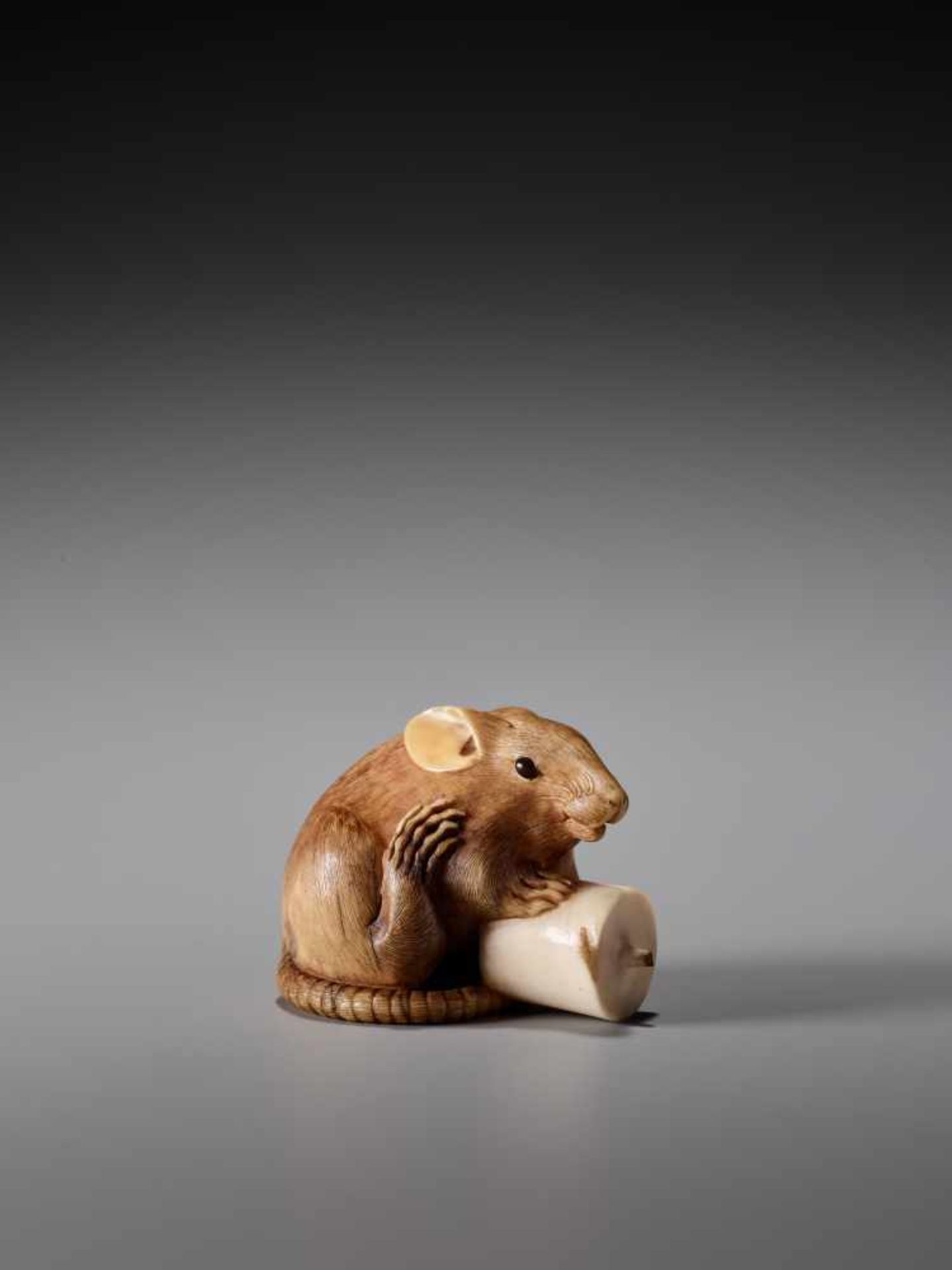 A RARE IVORY NETSUKE OF A RAT WITH CANDLE BY KANO TOMOKAZU Ivory netsuke Japan, Kyotoearly 19th