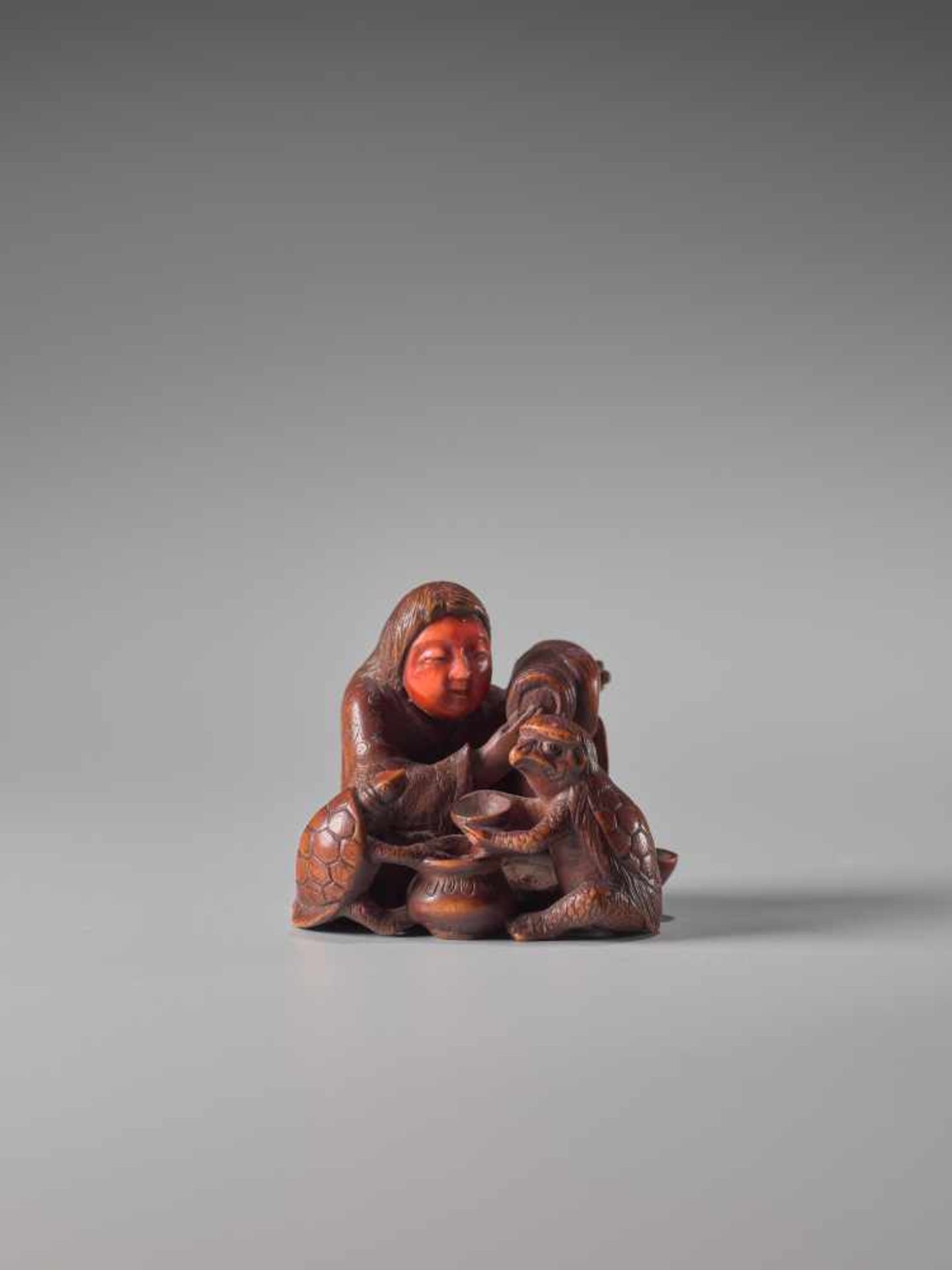 A WOOD AND IVORY NETSUKE OF A DRUNKEN SHOJO WITH MINOGAME AND KAPPAWood and ivory netsukeJapan19th