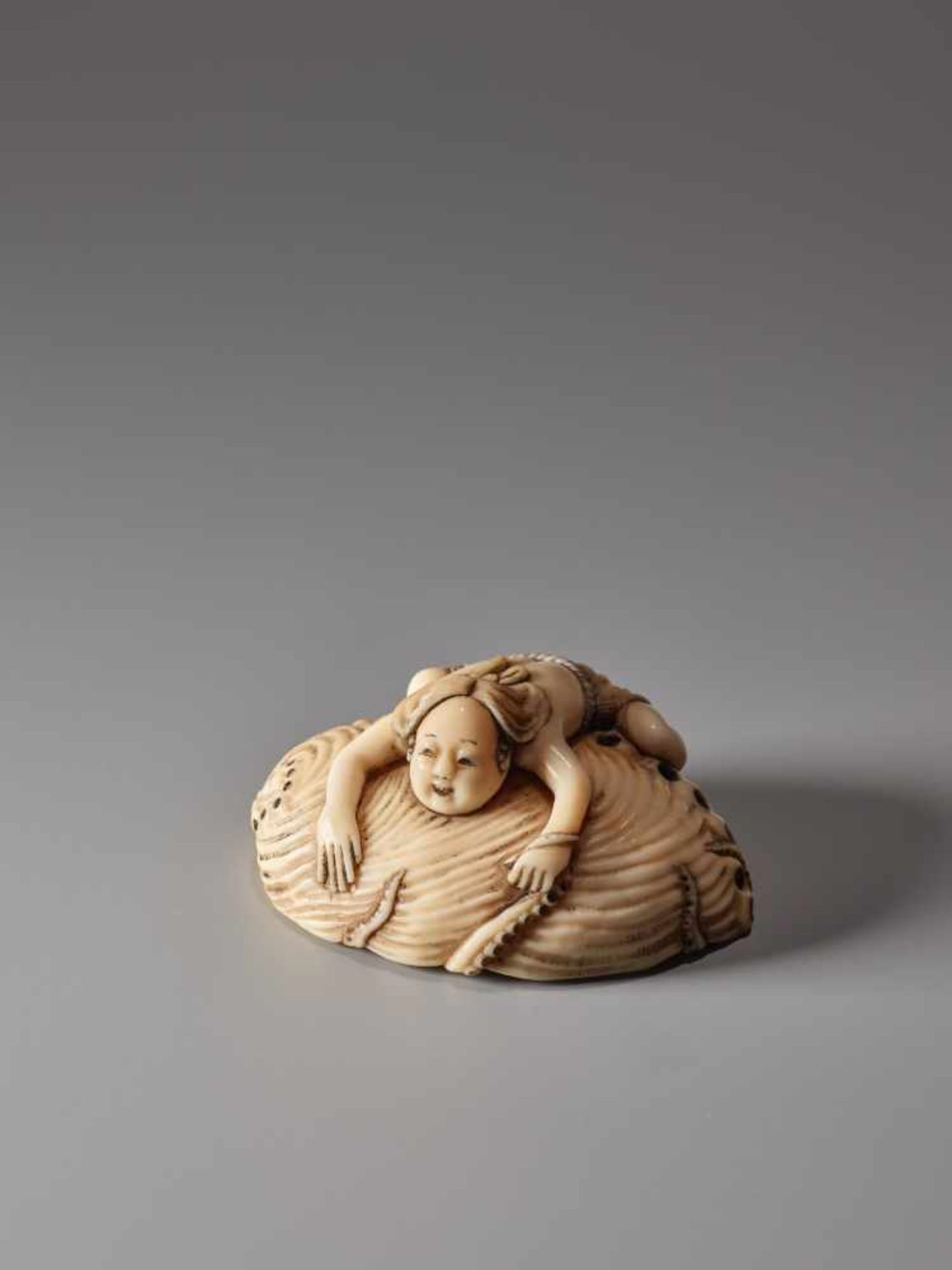 AN IVORY NETSUKE OF A FISHER GIRL AND OCTOPUS ON A GIANT AWABIIvory netsukeJapan19th century, Edo - Image 9 of 9