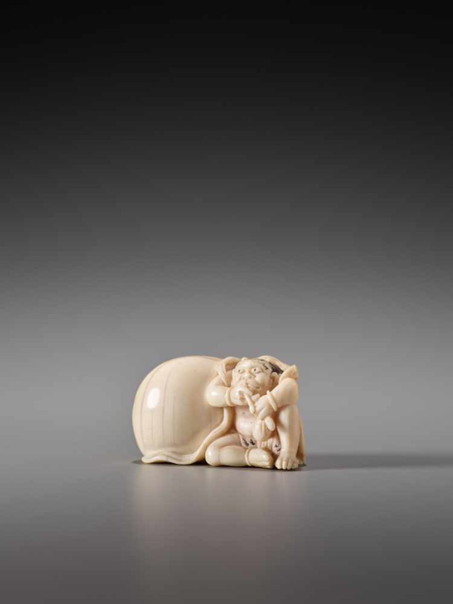 AN IVORY NETSUKE OF FUTEN WITH HIS BAG OF WIND BY TOMONOBUIvory netsukeJapan19th century, Edo period - Image 2 of 6