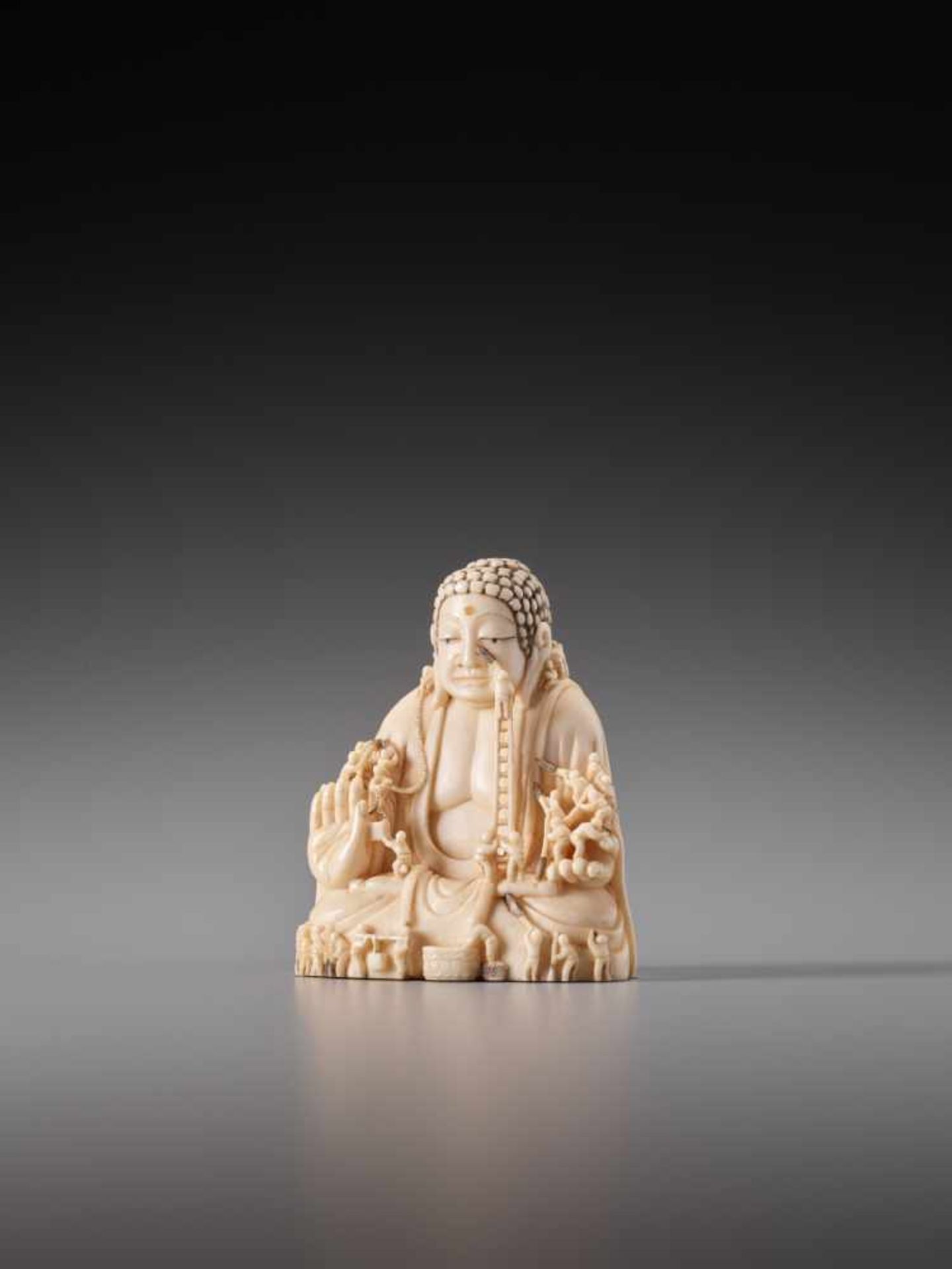 AN IVORY NETSUKE OF CLEANING THE NARA DAIBUTSU BY KEIUNIvory netsukeJapan, Kyoto/Uji20th