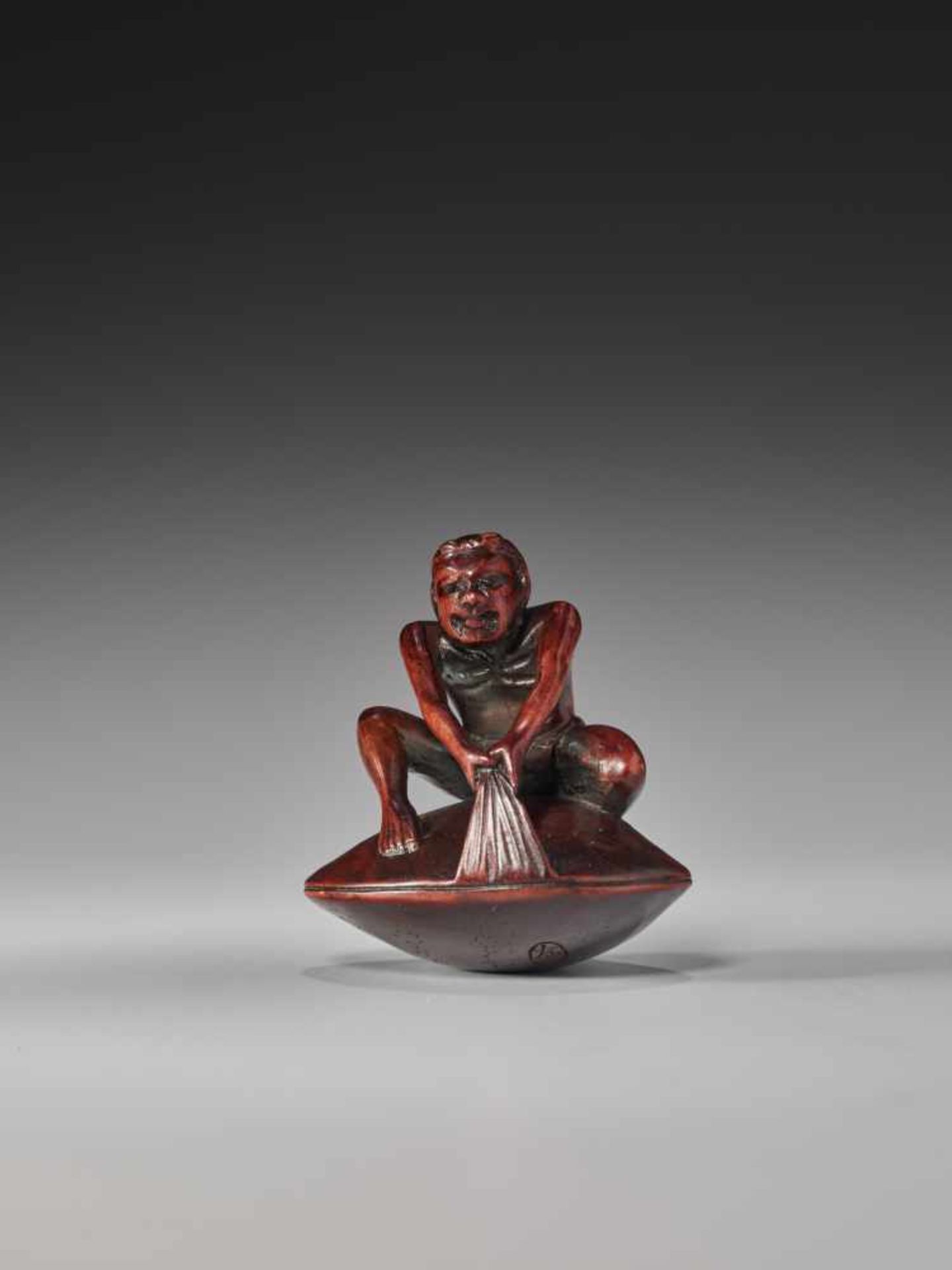 A FINE WOOD NETSUKE OF A FISHERMAN ON A CLAM BY TOMOKAZUWood netsukeJapan, Gifu19th century, Edo