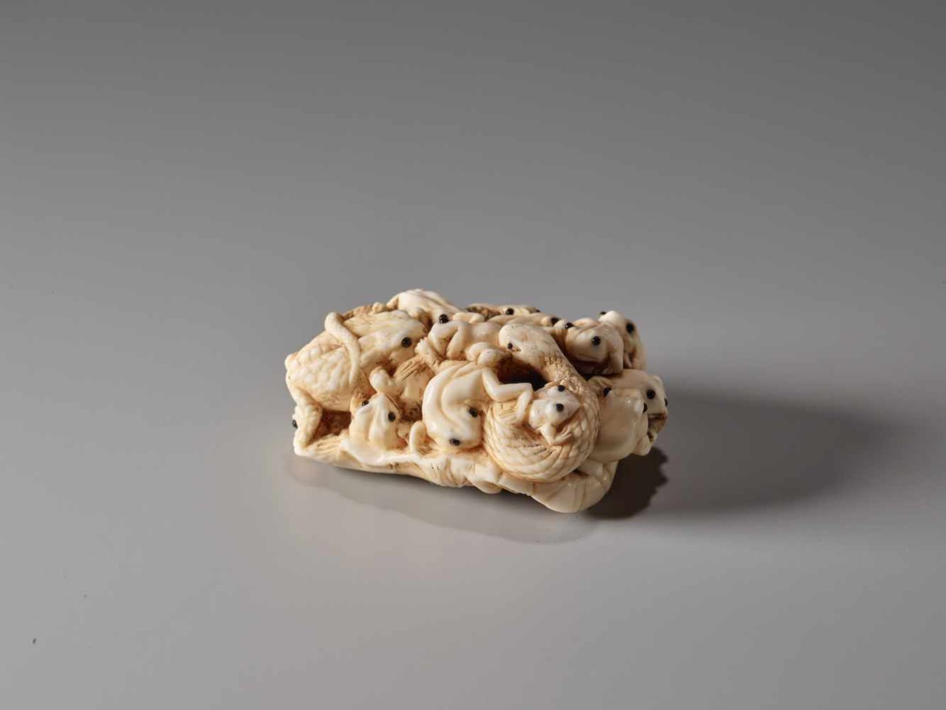 AN IVORY NETSUKE OF MANY TOADS ON A LOTUS LEAF BY MASAMITSUIvory netsukeJapanlate 19th century,