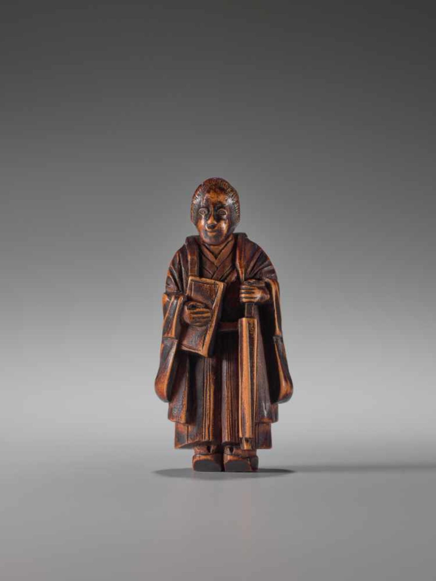 A WOOD NETSUKE OF A LADY WITH BOOK AND UMBRELLAWood netsukeJapan1st half of 19th century, Edo period