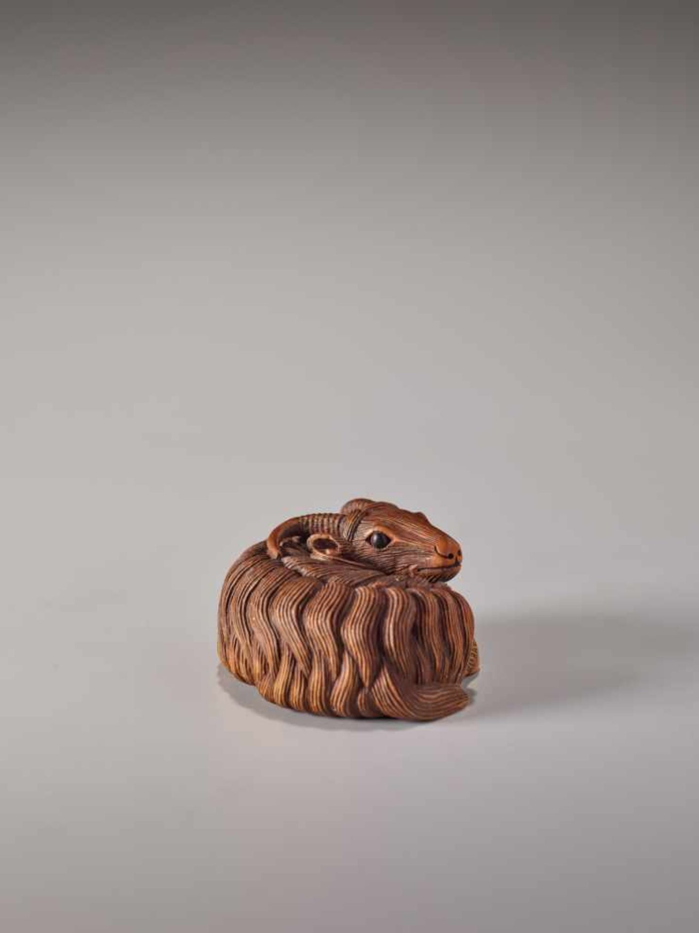 A FINE WOOD NETSUKE OF A RECUMBENT GOATWood netsukeJapan, Kyoto19th century, Edo period (1615-1868)A - Image 2 of 8