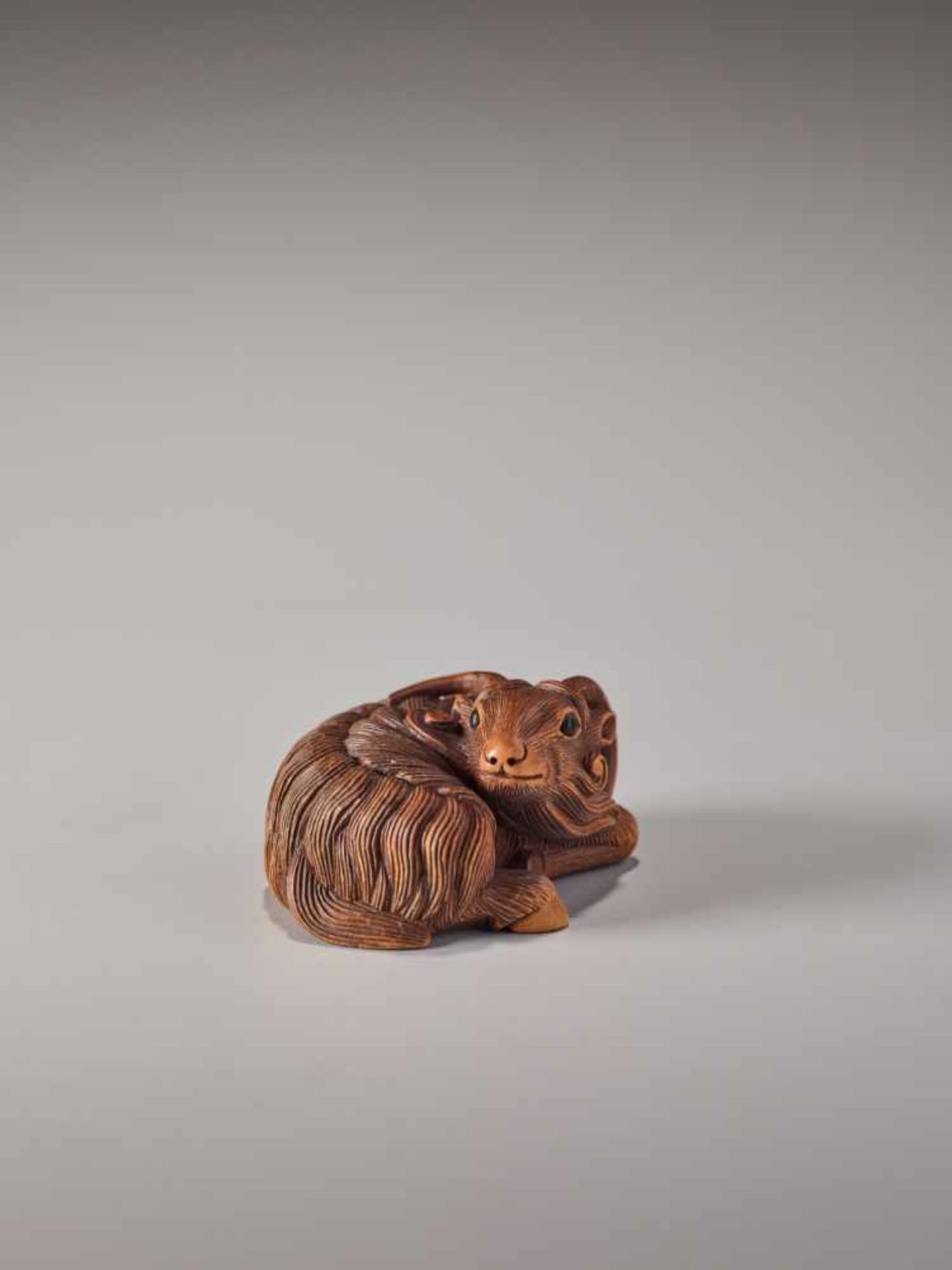 A FINE WOOD NETSUKE OF A RECUMBENT GOATWood netsukeJapan, Kyoto19th century, Edo period (1615-1868)A - Image 7 of 8