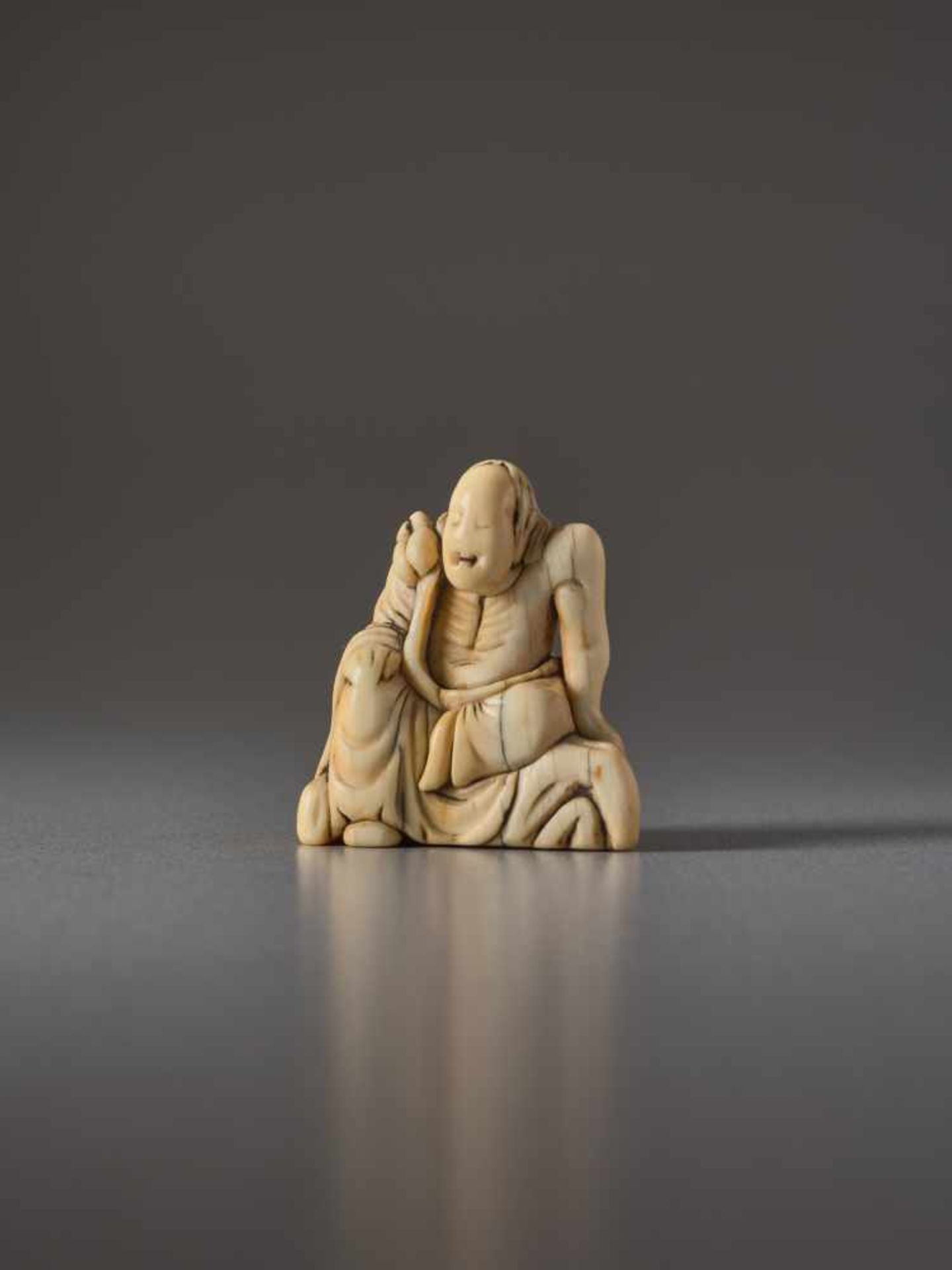 AN IVORY NETSUKE OF AN IMMORTAL ON A ROCKIvory netsukeJapan18th century, Edo period (1615-1868)Large