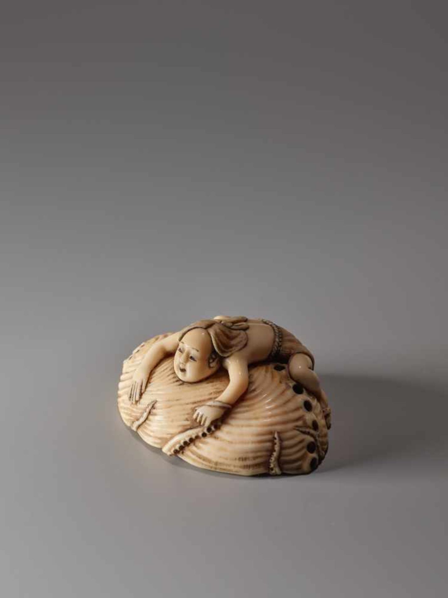 AN IVORY NETSUKE OF A FISHER GIRL AND OCTOPUS ON A GIANT AWABIIvory netsukeJapan19th century, Edo - Image 5 of 9