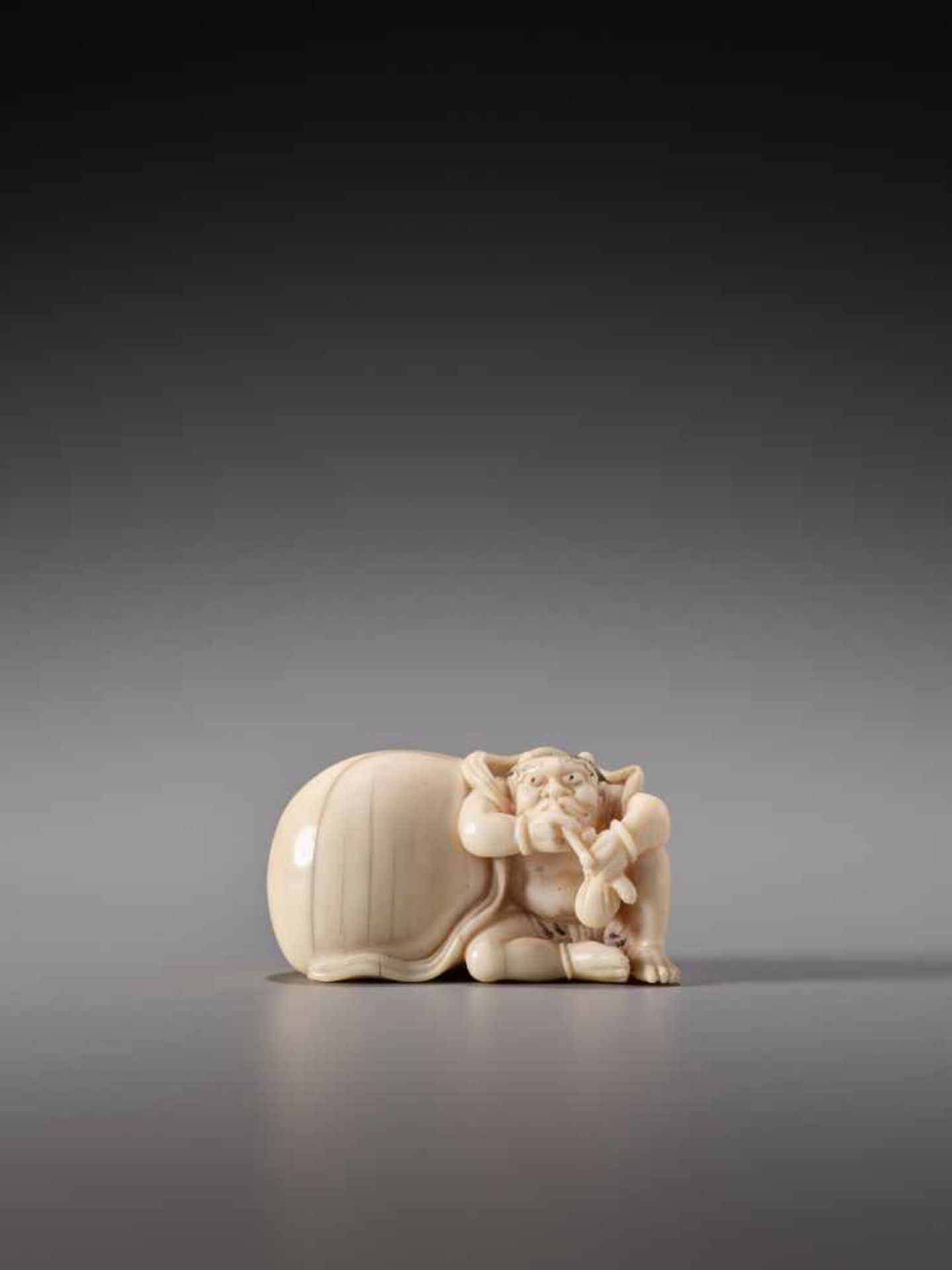 AN IVORY NETSUKE OF FUTEN WITH HIS BAG OF WIND BY TOMONOBUIvory netsukeJapan19th century, Edo period