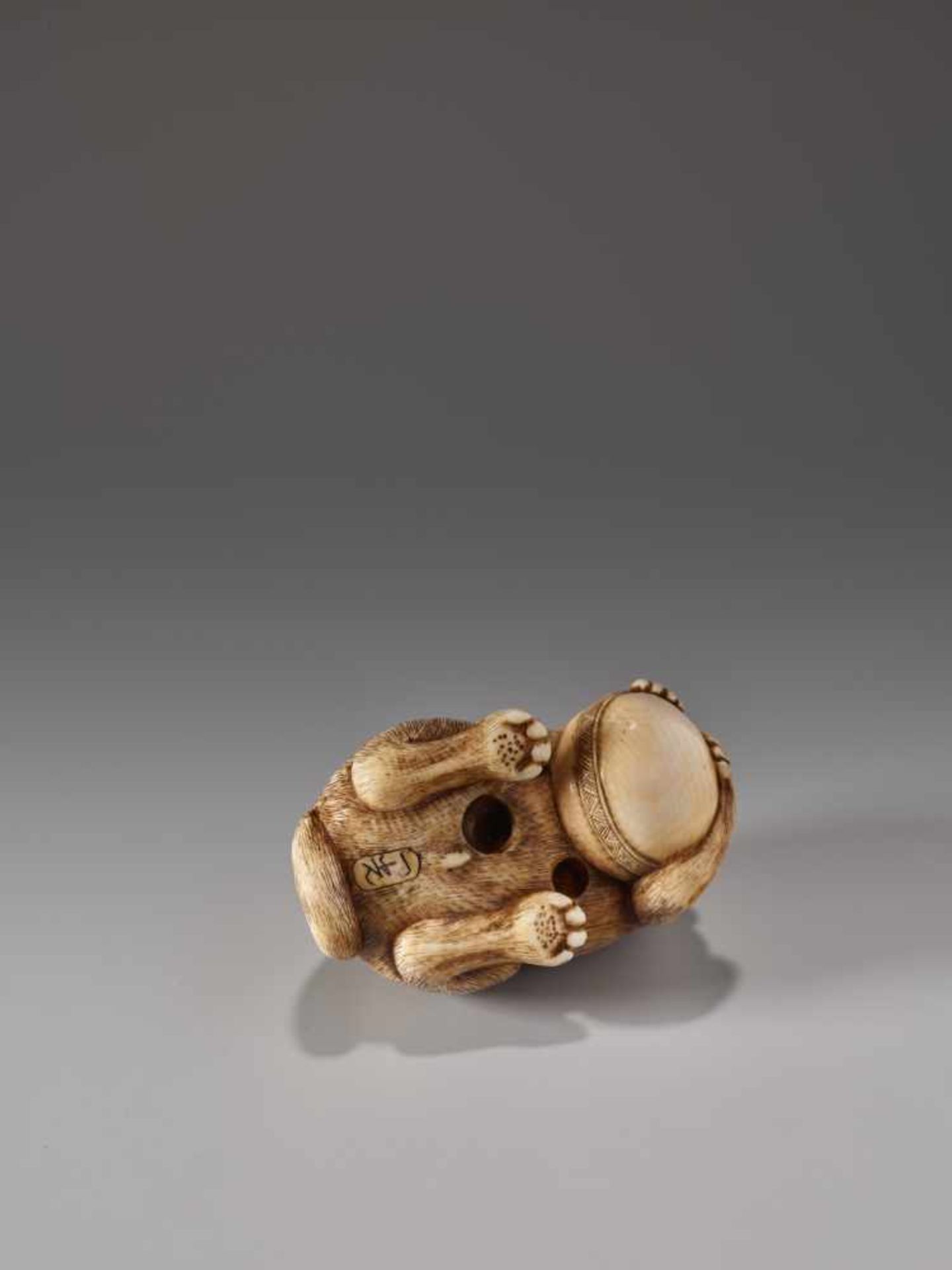 AN IVORY NETSUKE OF A DOG WITH A BALL BY IKKOIvory netsukeJapan, Nagoya19th century, Edo period ( - Image 4 of 7