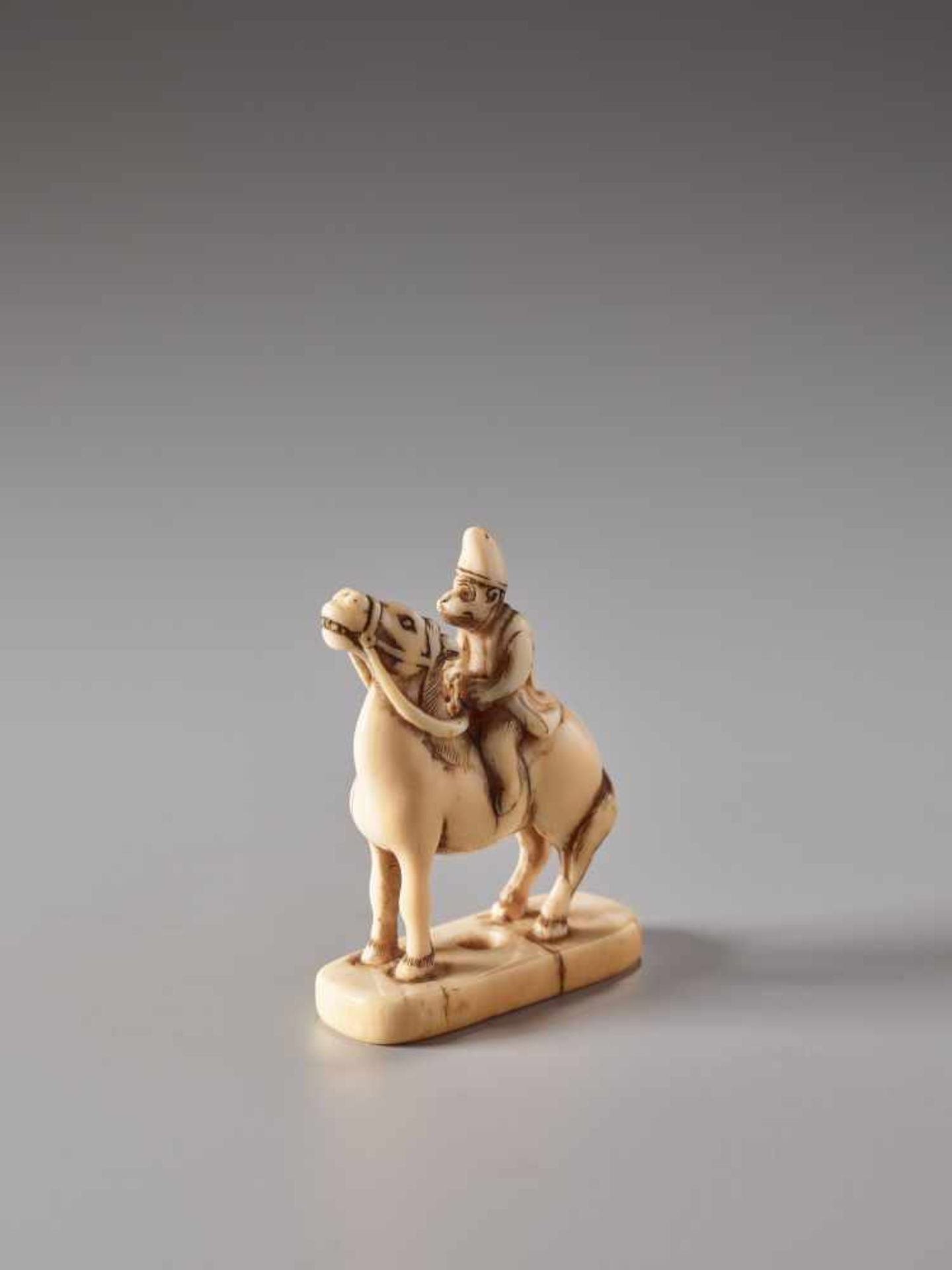 AN IVORY NETSUKE OF A MONKEY ON A HORSEIvory netsukeJapan19th century, Edo period (1615-1868)The