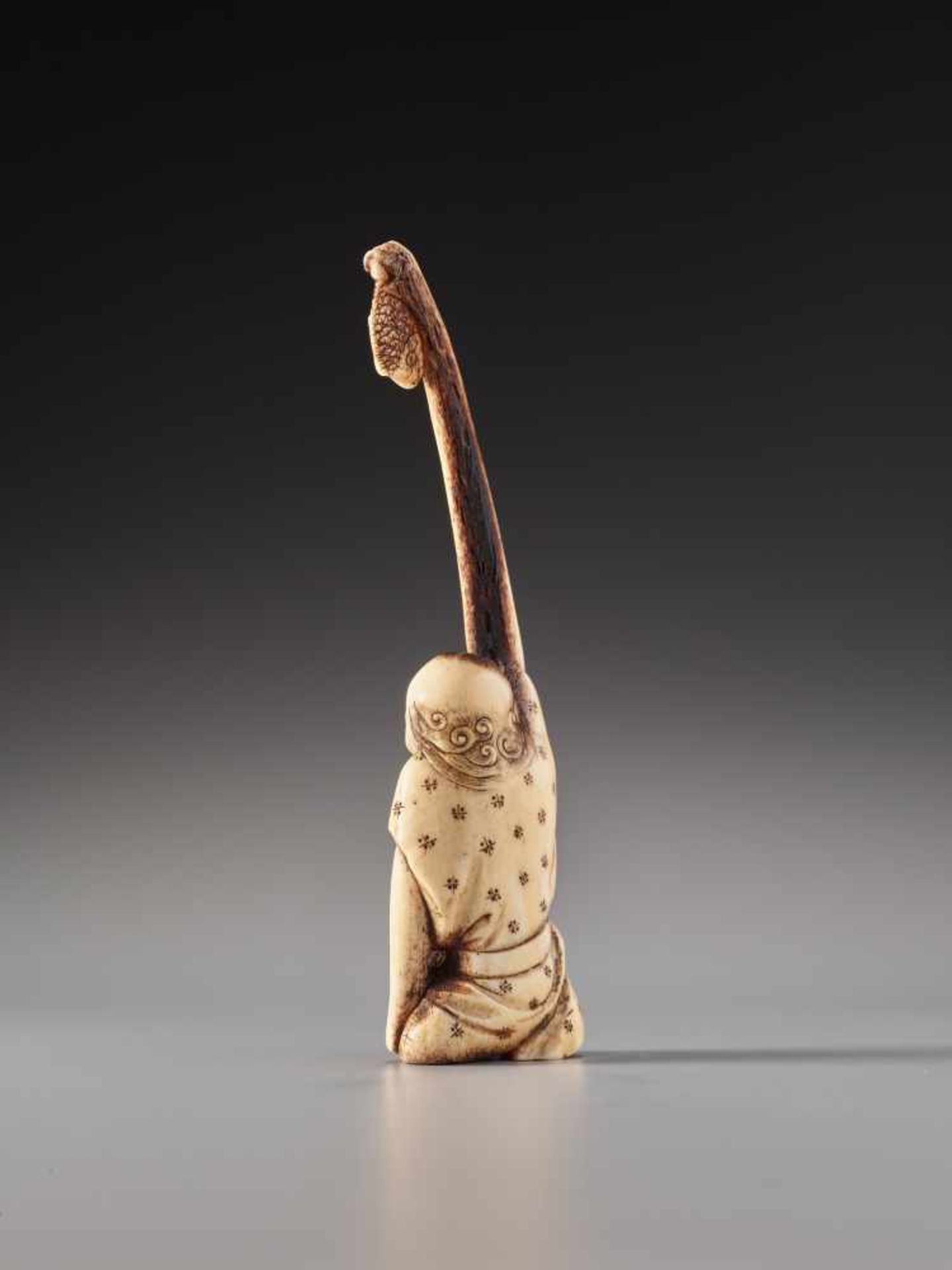 A STAG-ANTLER NETSUKE OF TENAGA WITH SEA BREAMStag antler sashi netsukeJapan19th century, Edo period - Image 3 of 5