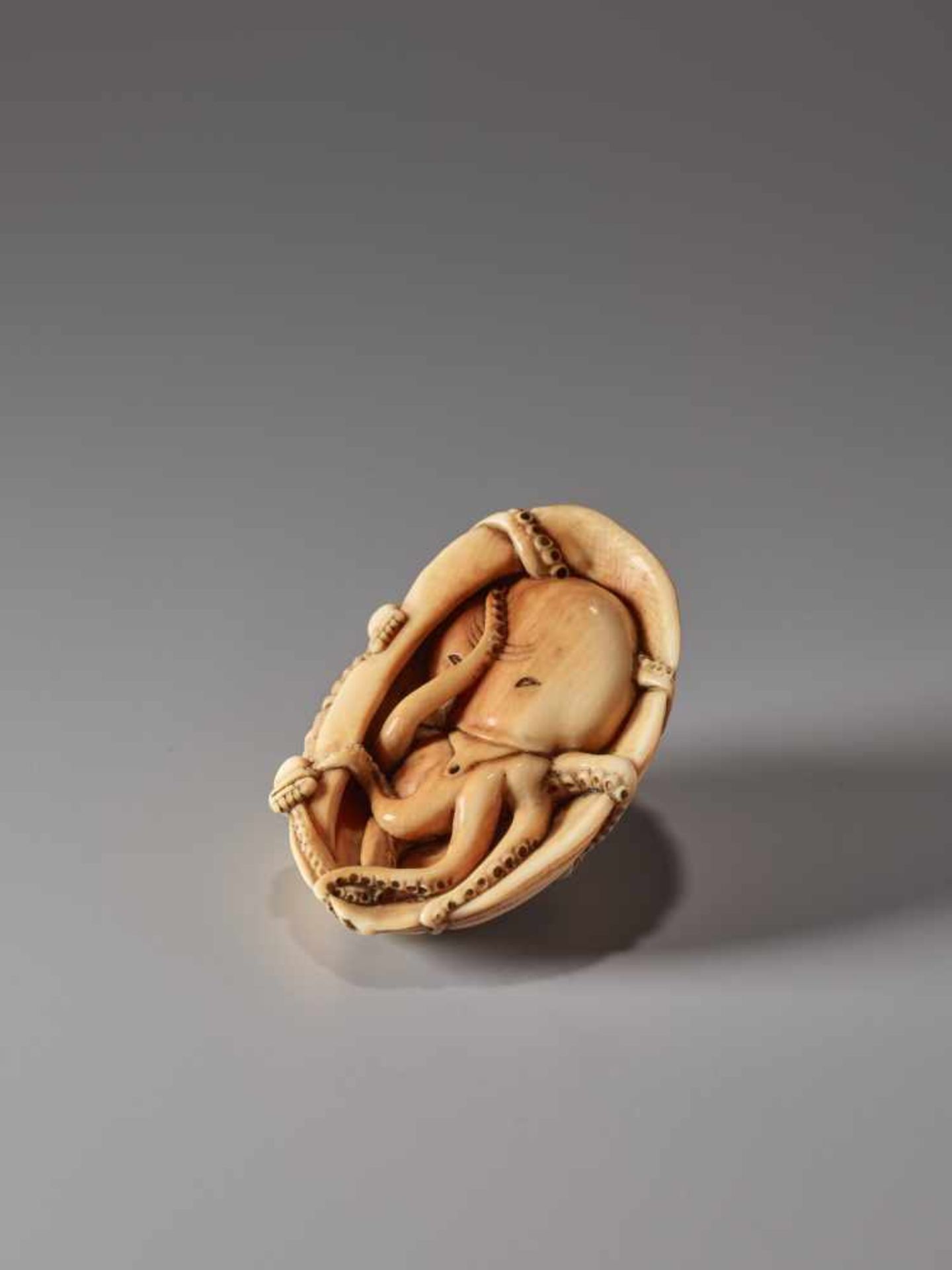 AN IVORY NETSUKE OF A FISHER GIRL AND OCTOPUS ON A GIANT AWABIIvory netsukeJapan19th century, Edo - Image 3 of 9