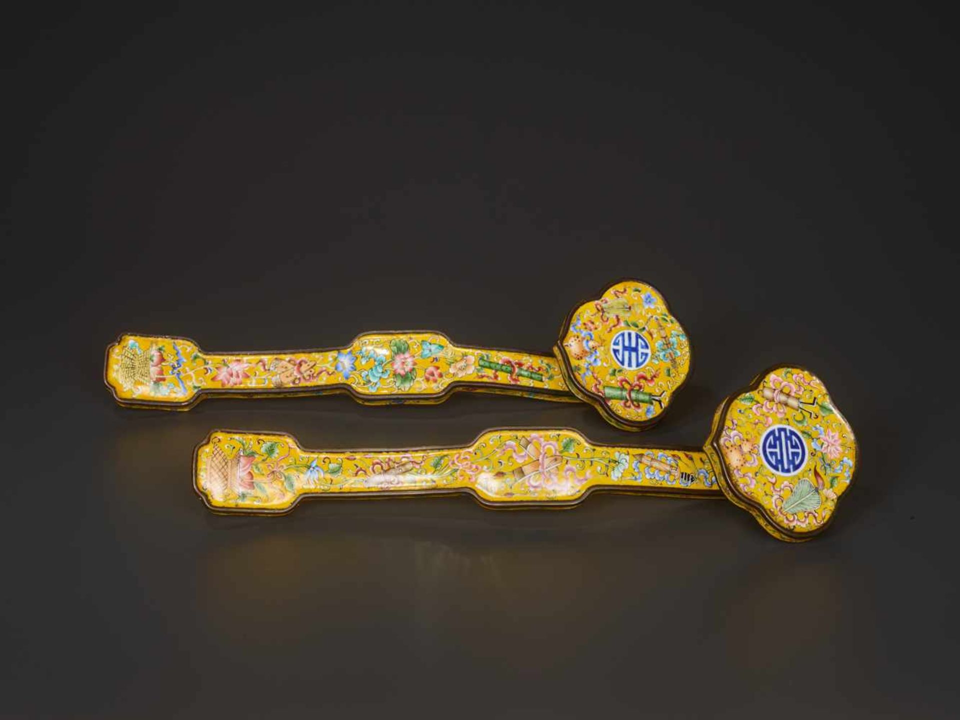 A PAIR OF QING DYNASTY CANTON ENAMEL RUYI SCEPTRES Enamel on copper bronze China, Qing Dynasty