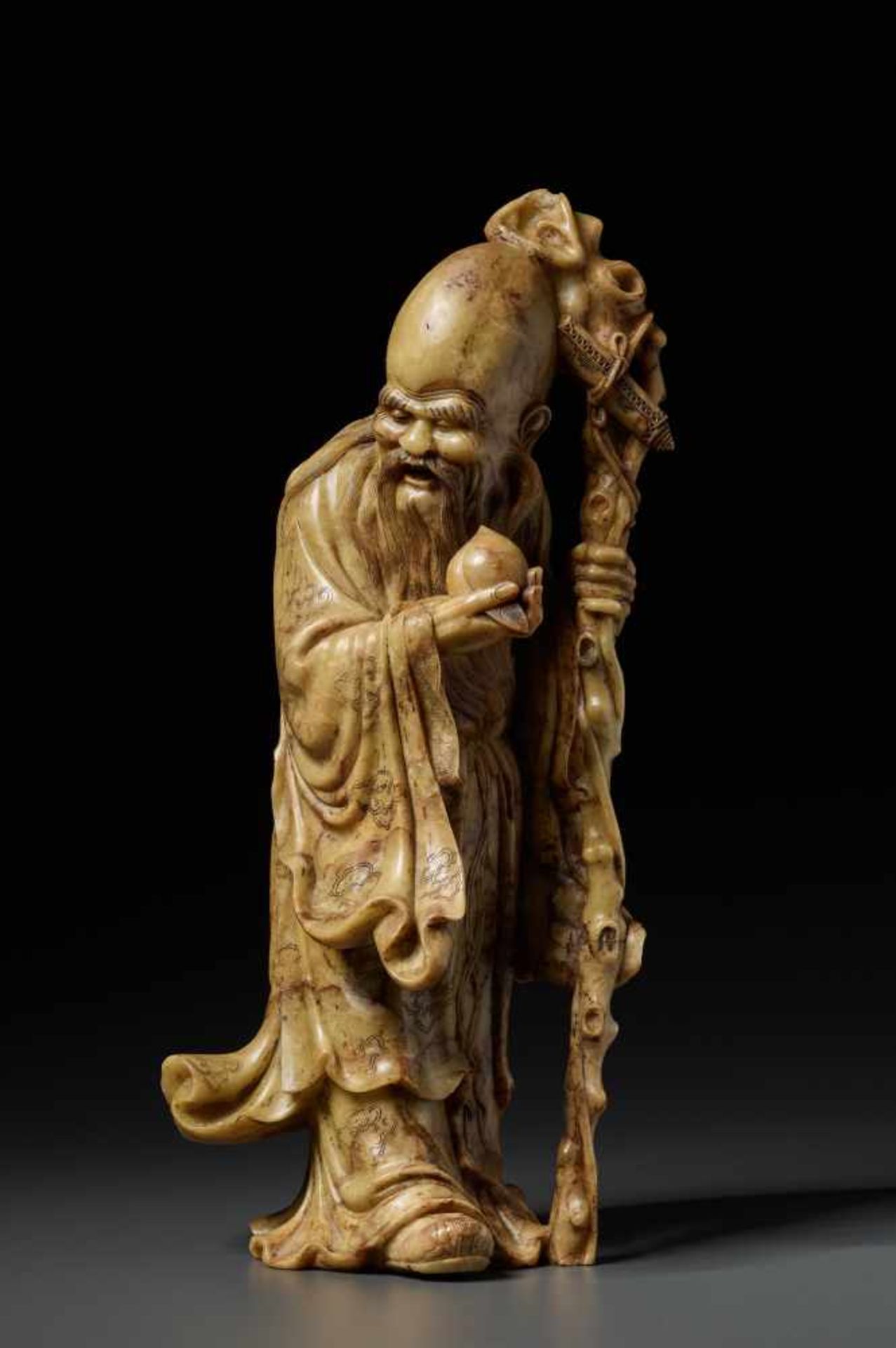 A SOAPSTONE FIGURE OF SHOULAO, QING DYNASTY, 19TH CENTURYThe beige stone finished with a refined