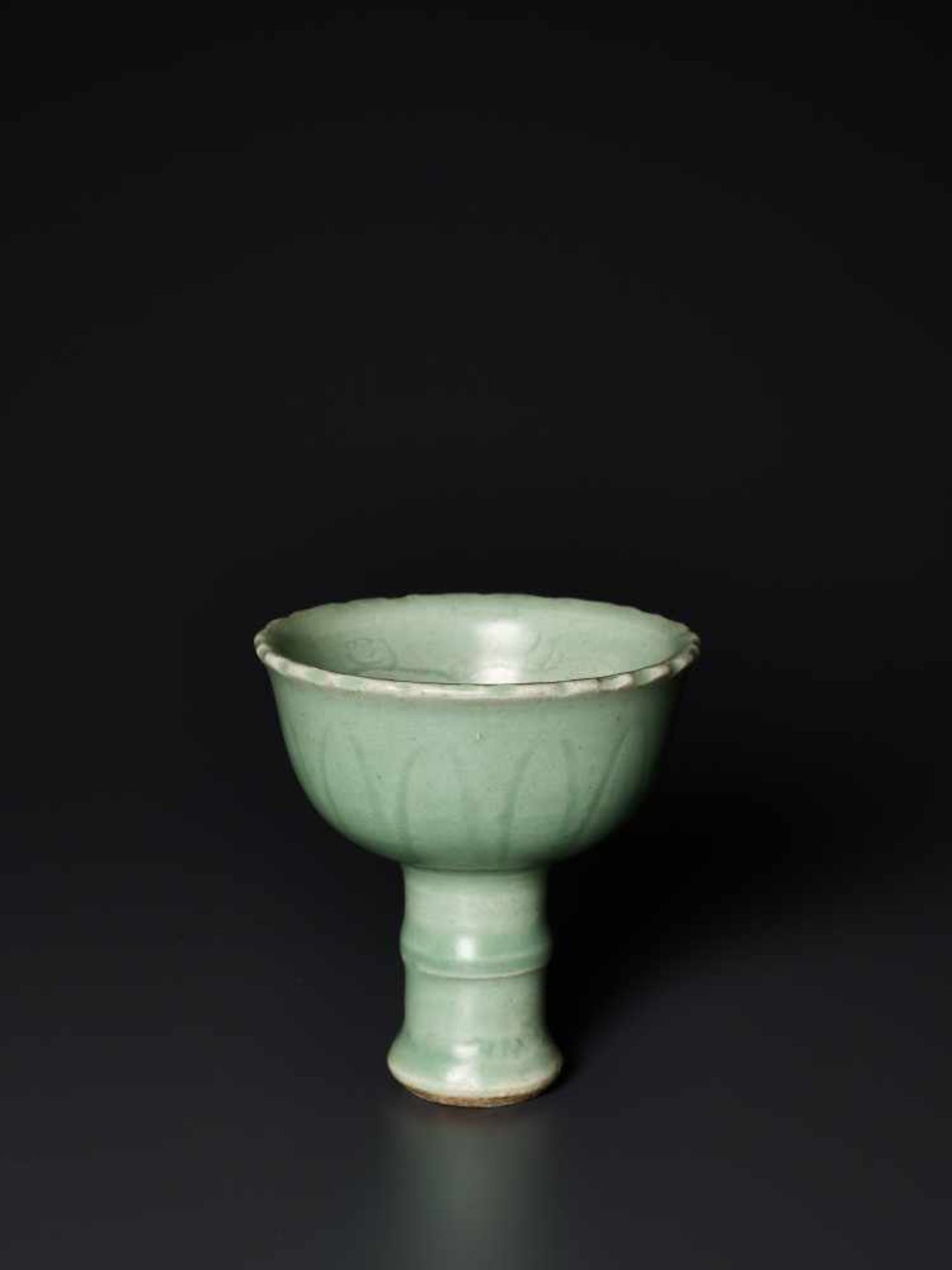 AN INCISED LONGQUAN CELADON STEM CUP, YUAN DYNASTYThe elegant and almost flawless celadon glaze