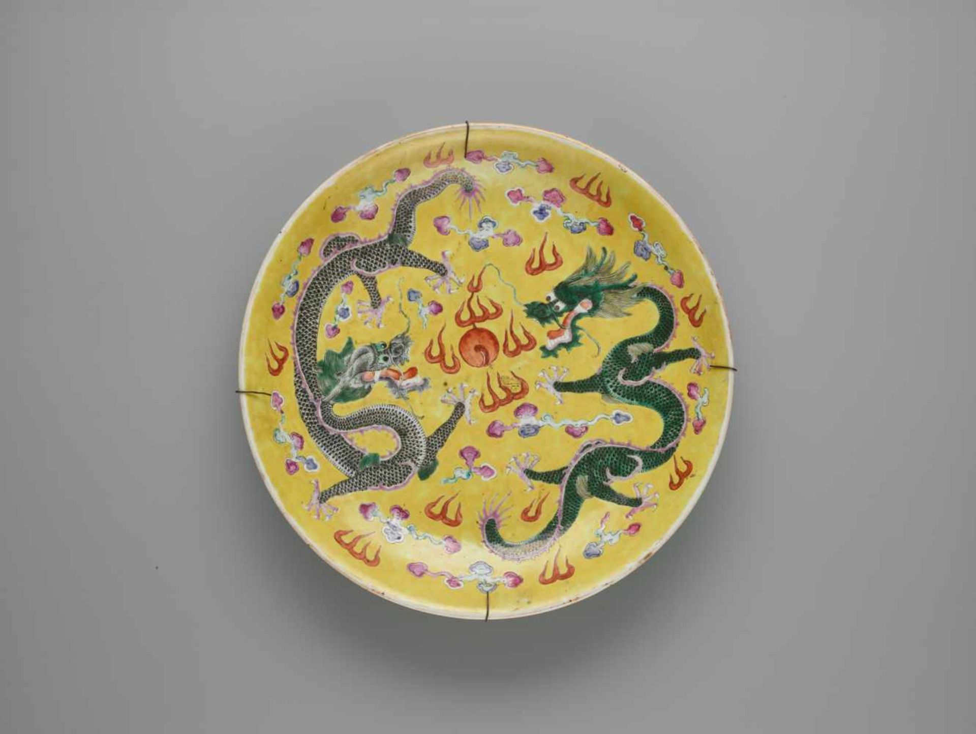 A ‘DRAGON’ PORCELAIN CHARGER, LATE QING DYNASTYThe massively potted plate painted in polychrome