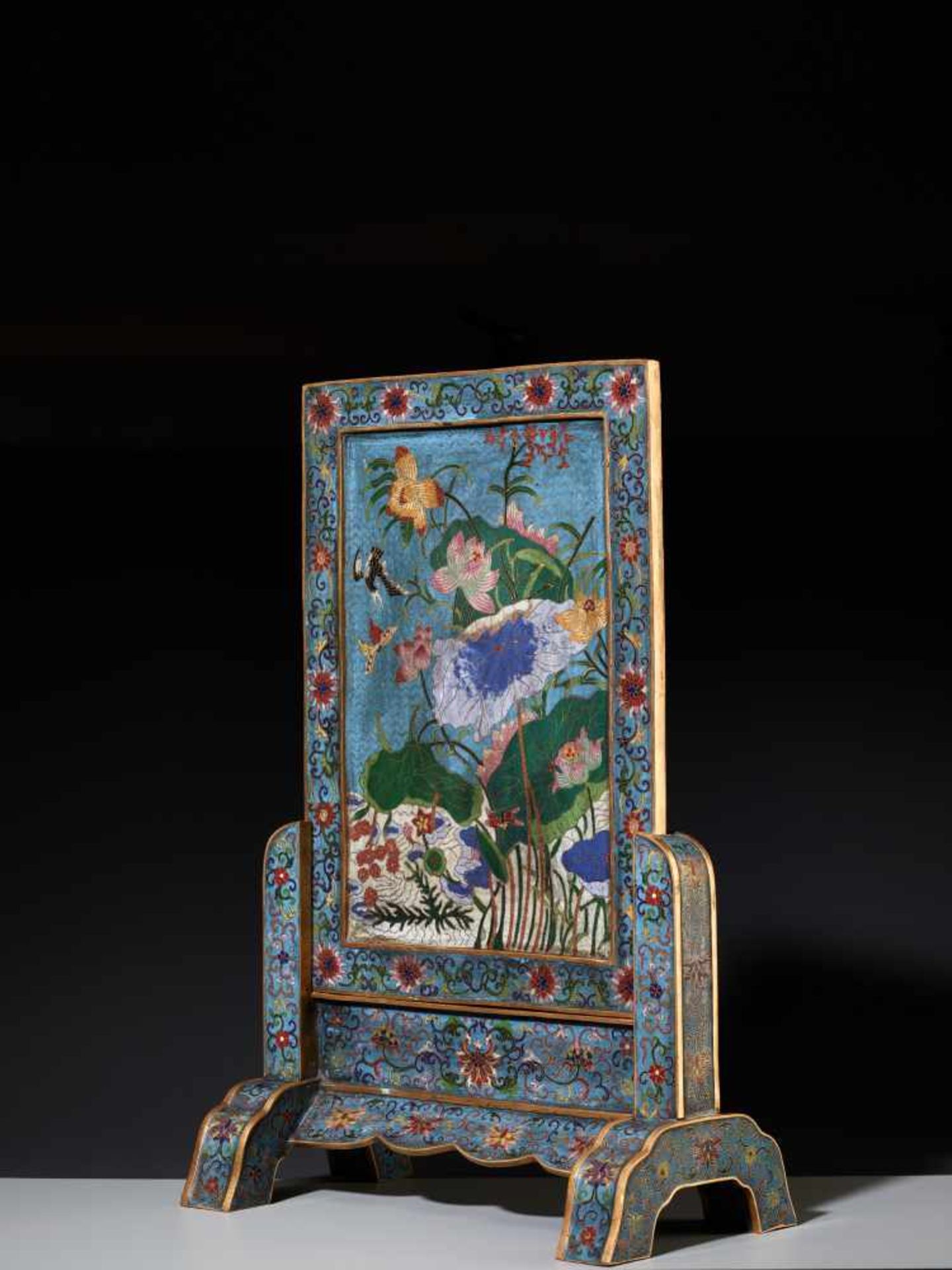 A CLOISONNE ‘LOTUS’ TABLE SCREEN AND STAND Cloisonné enamel on gilt bronze bodyChina, late Qing