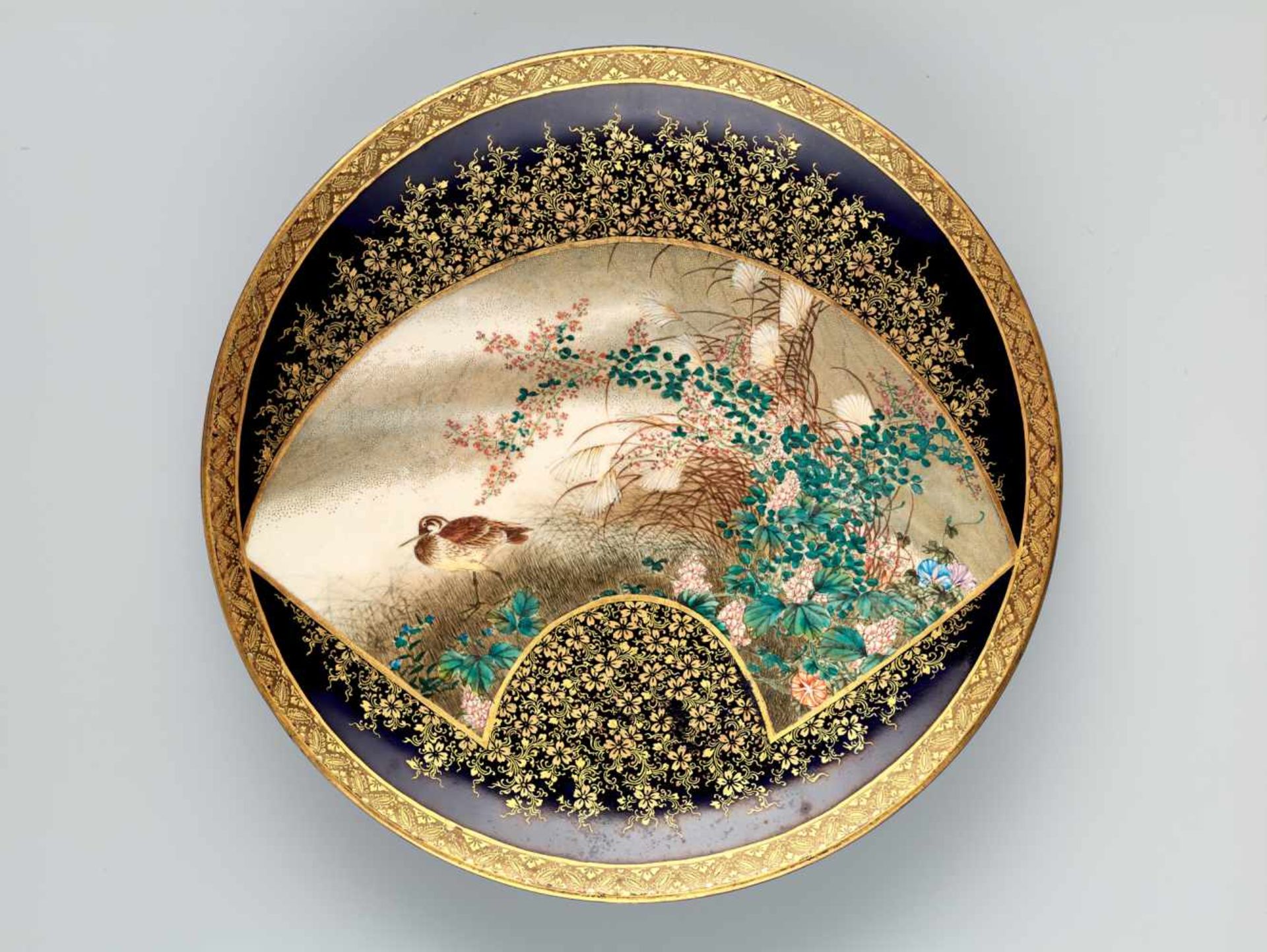 A FINE SATSUMA PLATE BY KINKOZAN DECORATED WITH A SNIPE AMONGST BLOSSOMSSatsuma ceramicJapan, late