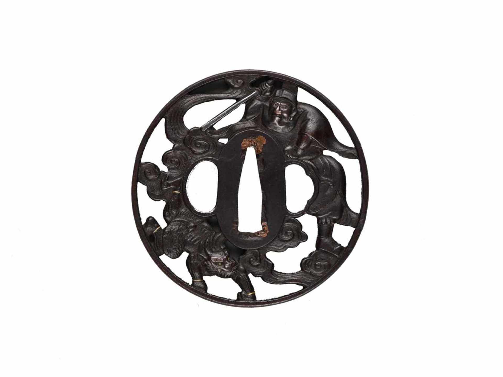 AN IRON TSUBA DEPICTING SHOKI AND ONIIronJapan, 19th century, Edo period (1615-1868)The patinated