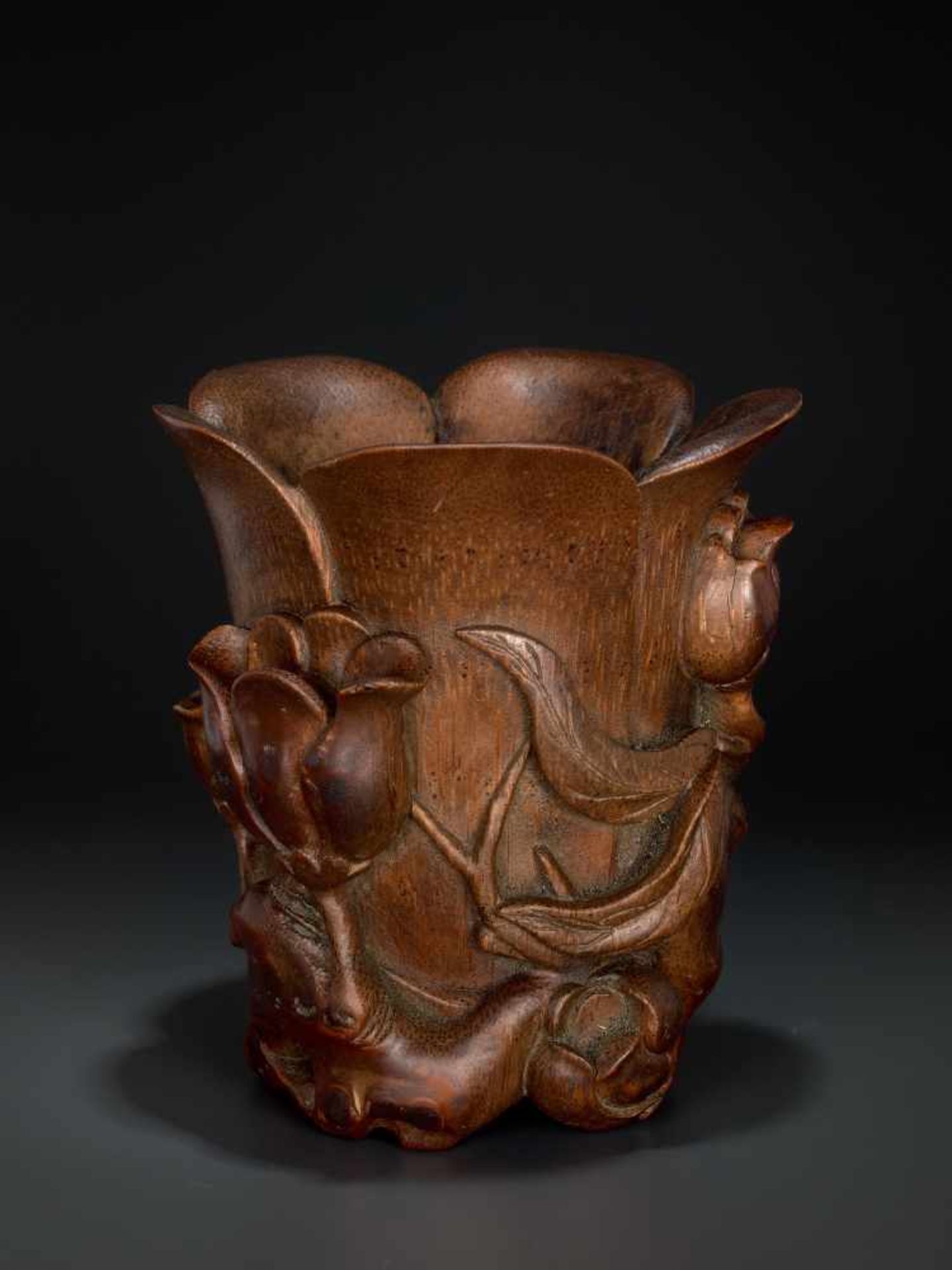 A CARVED KANGXI PERIOD BAMBOO ‘MAGNOLIA’ LIBATION CUP Bamboo, black lacquer China, Kangxi period (