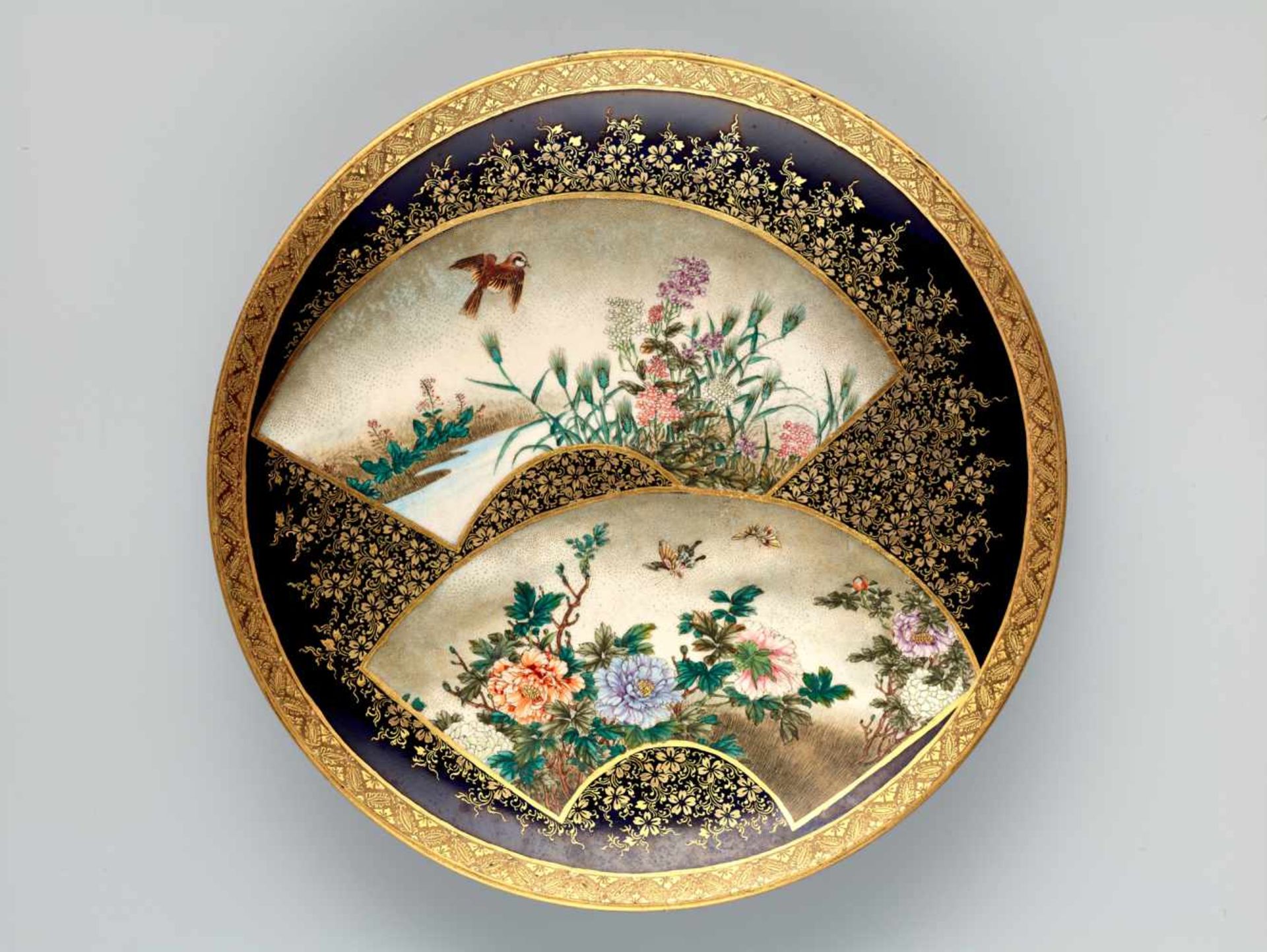 A FINE SATSUMA PLATE BY KINKOZAN DEPICTING BLOSSOMS, BUTTERFLIES AND SPARROWSatsuma ceramicJapan,