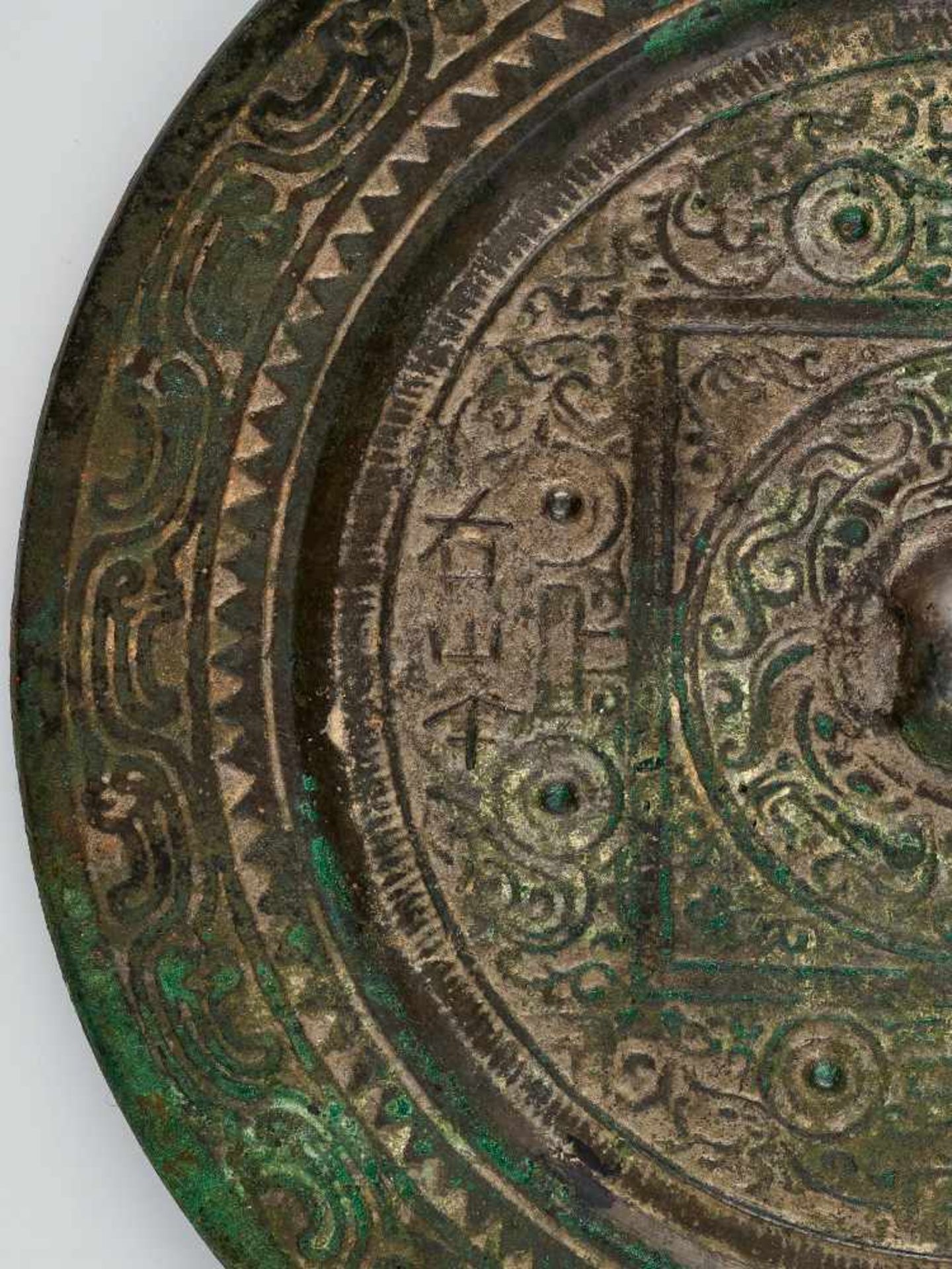 A LARGE INSCRIBED 'TLV' BRONZE MIRROR, HAN DYNASTYCast bronze with high relief, the patina with - Image 3 of 6