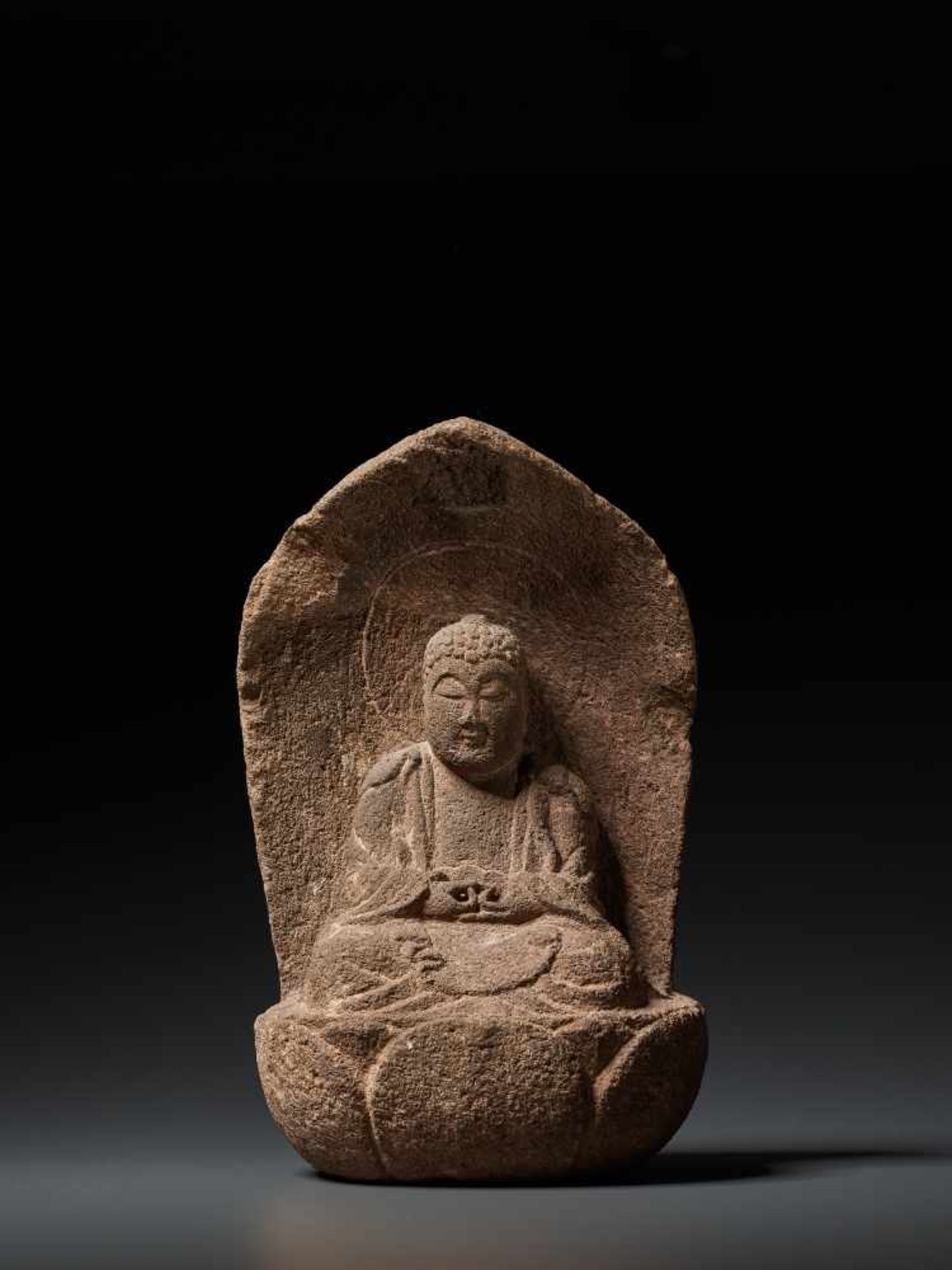 A MUROMACHI PERIOD STONE FIGURE OF BUDDHA AMIDA NYORAI Reddish-grey Sandstone, sculpted Japan,