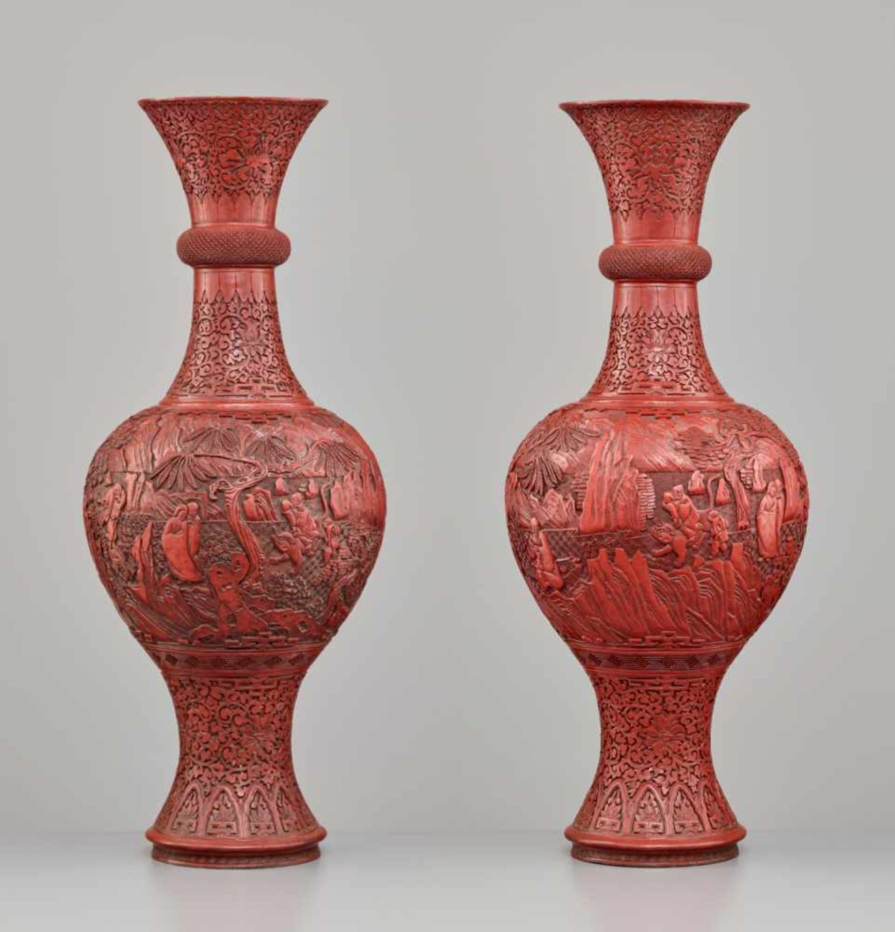 A LARGE PAIR OF CINNABAR LACQUER ‘EIGHT IMMORTALS’ VASES, QING DYNASTYThe body entirely covered with