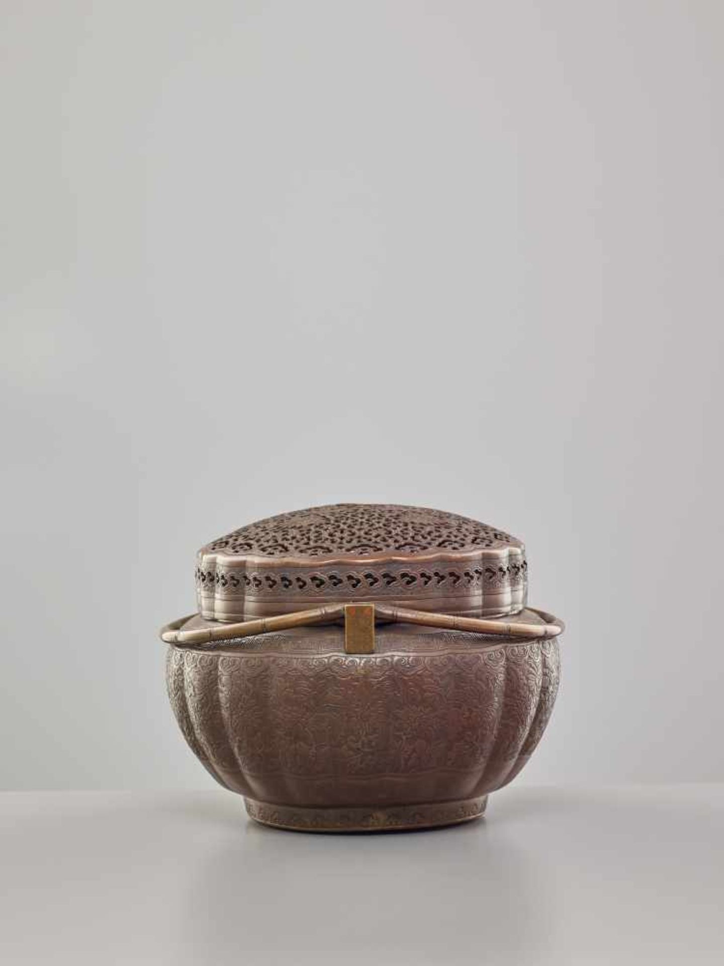 A COPPER HAND-WARMER WITH RETICULATED COVER, QING DYNASTYThe metal with an even reddish-brown - Image 5 of 15