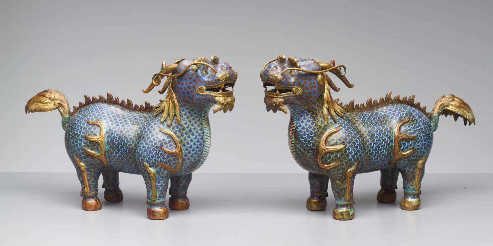 TWO CLOISONNÉ ENAMEL QILIN, QING DYNASTY The bronze bodies with polychrome cloisonné enamels and