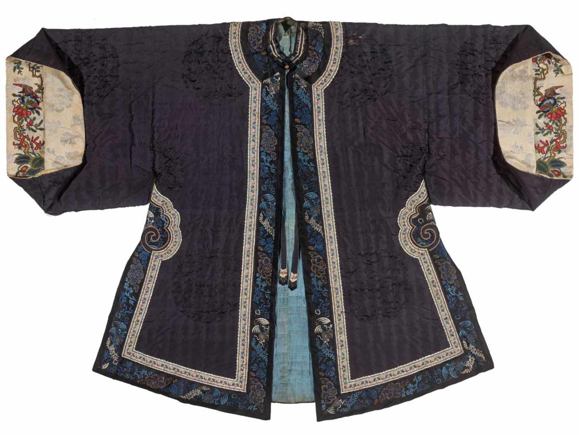A PADDED WINTER SURCOAT WITH PEKINESE STITCH EMBROIDERY, QINGTextured silk with multi-colored silk