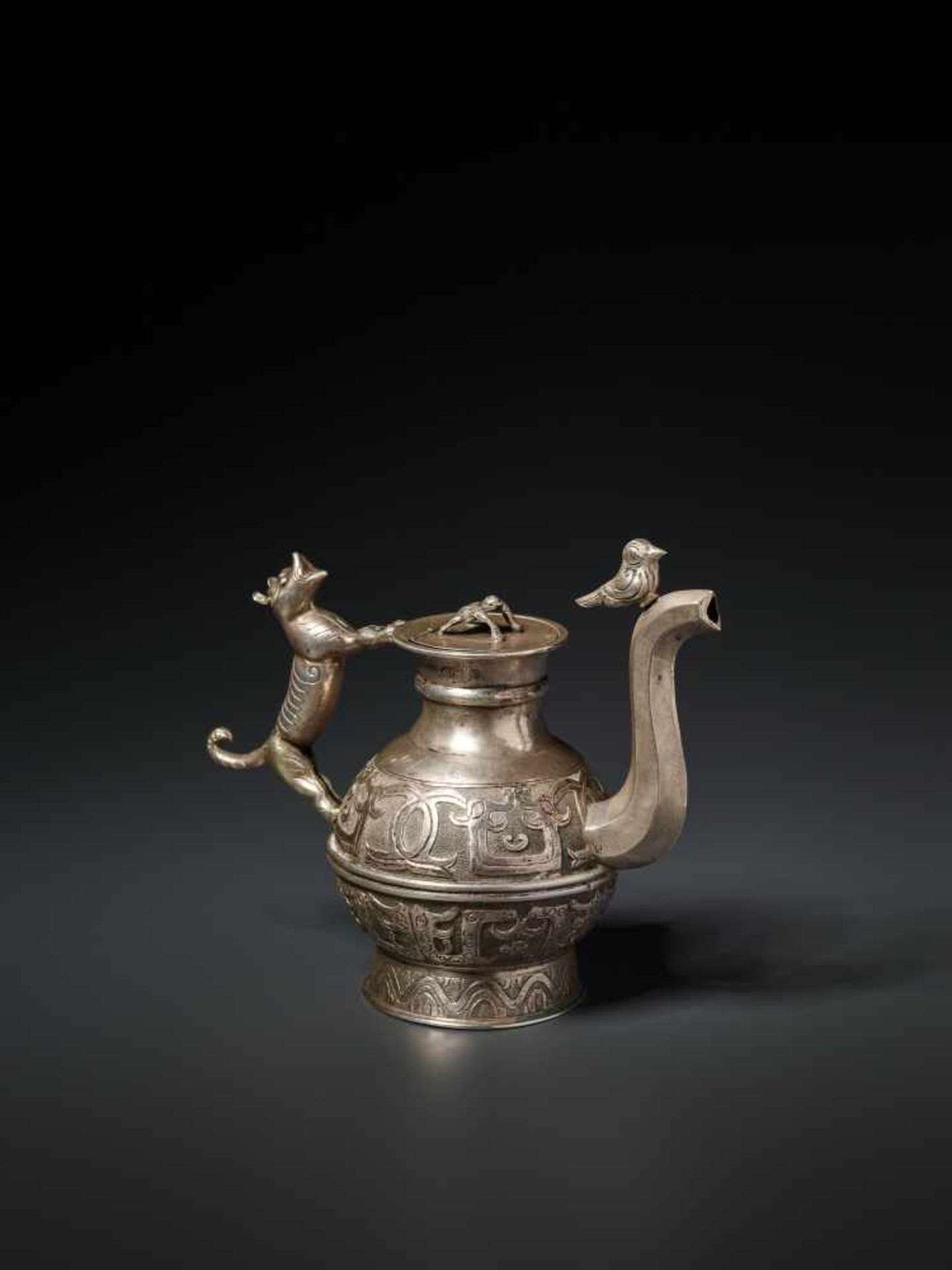 A WELL-CRAFTED ARCHAISTIC SILVER EWER, QING DYNASTY Silver, cast and chased China, Qing Dynasty This